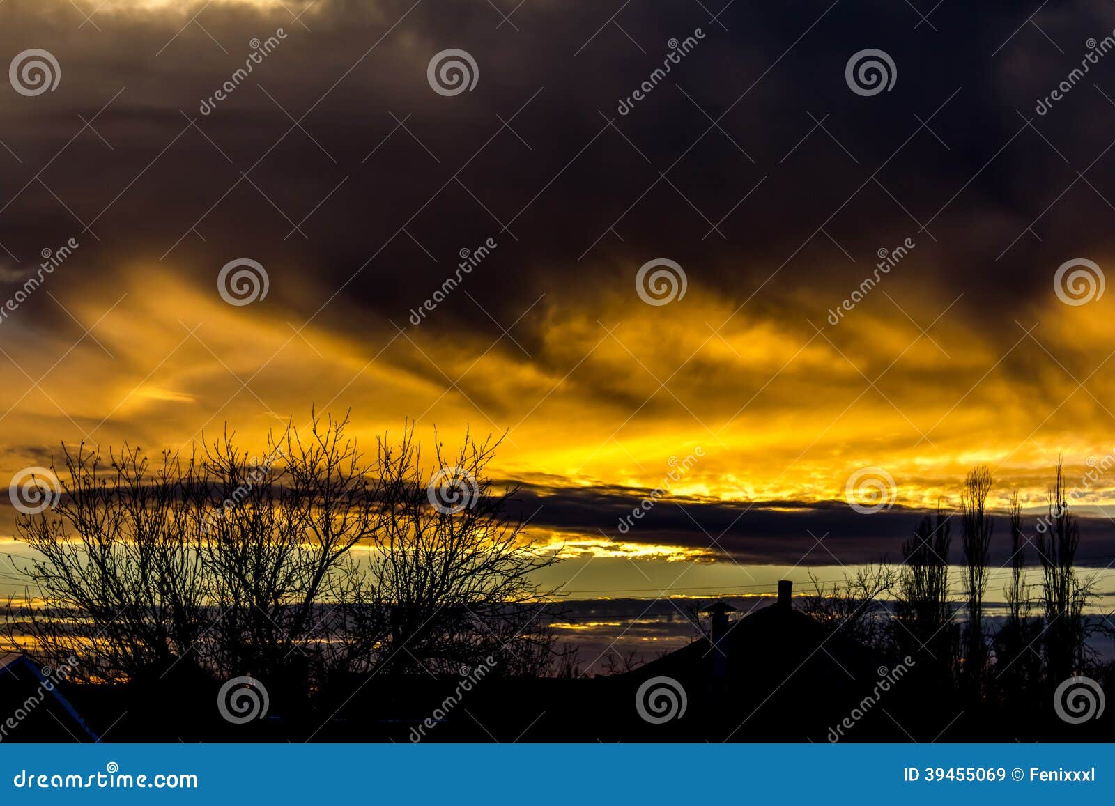 Fiery sunset. Rays of the setting sun breaking through the clouds