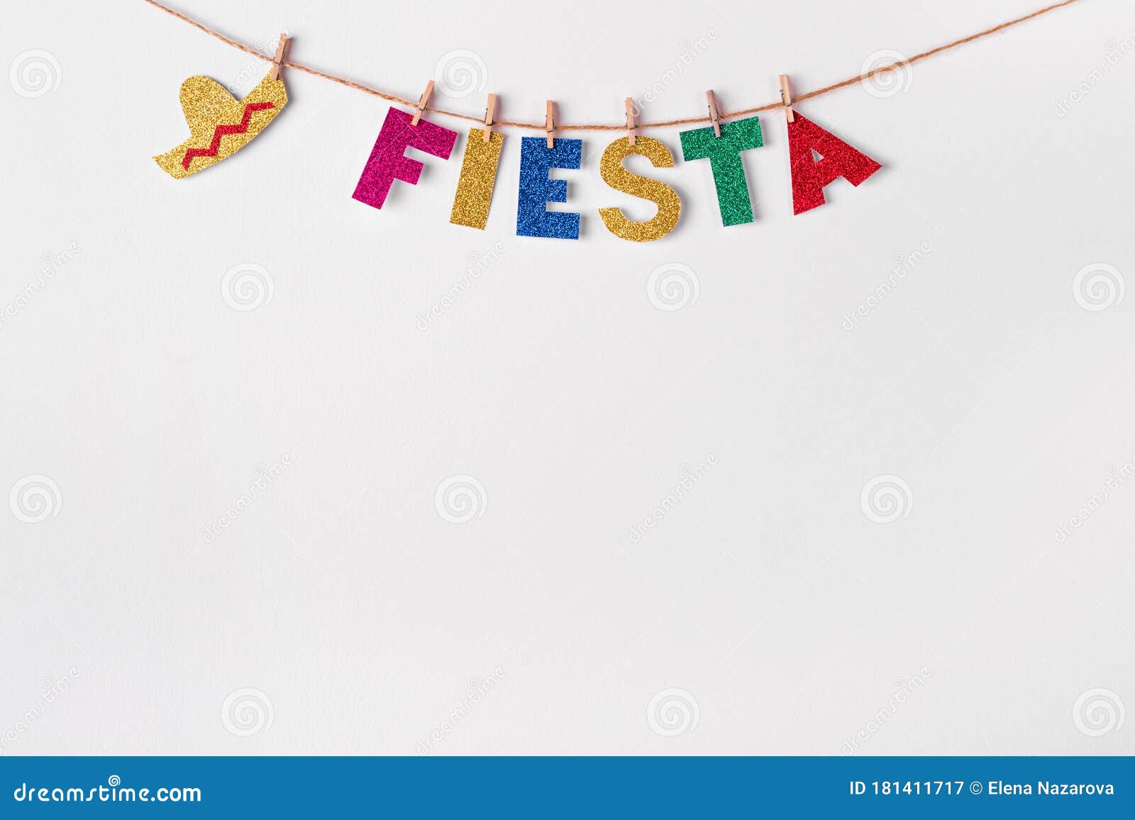 fiesta word on pins against white wall background. fragment of festive diy decoration of interior. cinco de mayo celebration