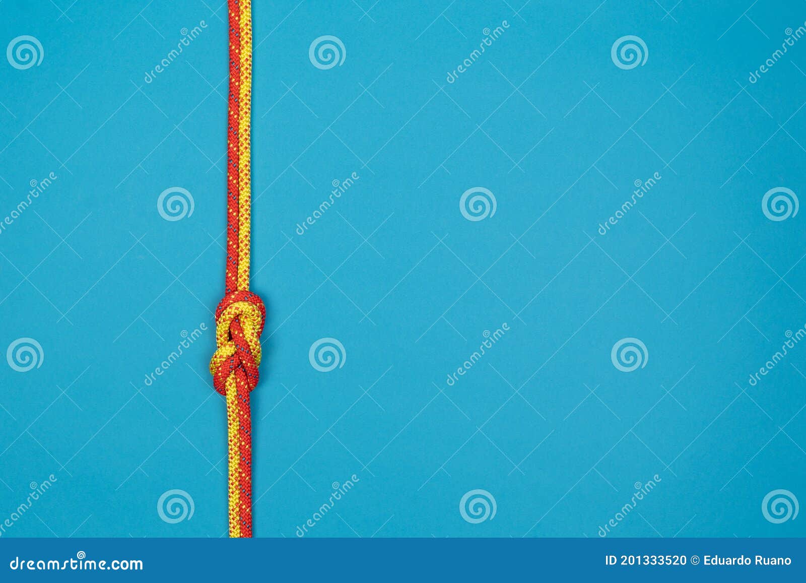 Figureeight Knot with Red and Yellow Climbing Ropes on Blue Background