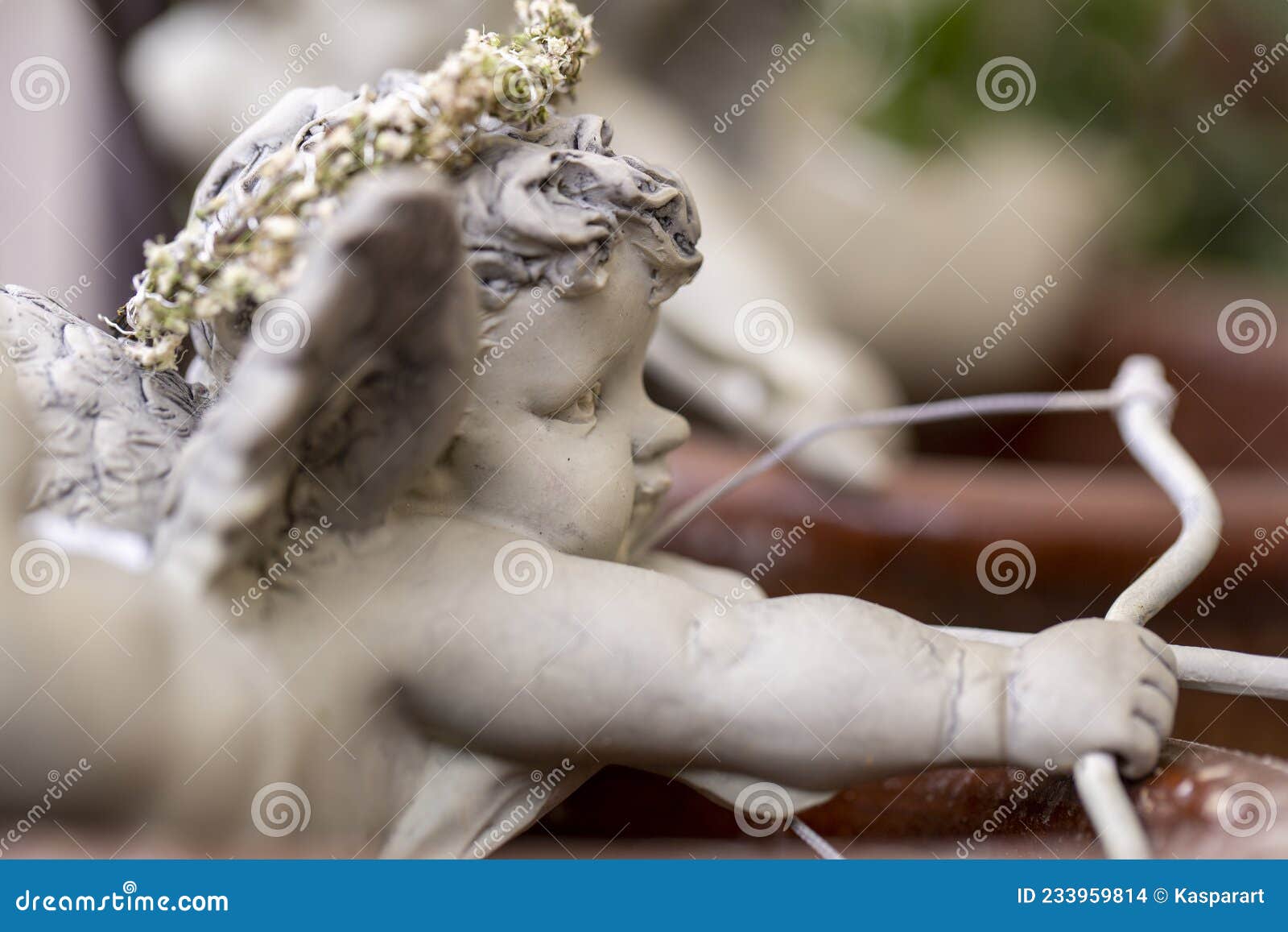figurine of amor aiming with bow and arrow