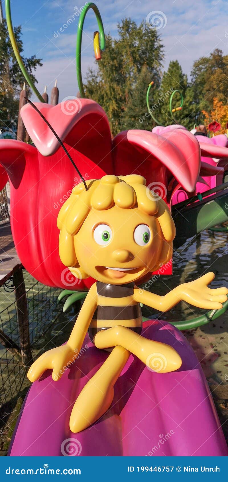 Figurine of Cartoon Character Maya the Bee,sitting on Purple Petal in  Holiday Park on Sunny Day Against Flower Backdrop Editorial Photography -  Image of entertainment, autumn: 199446757