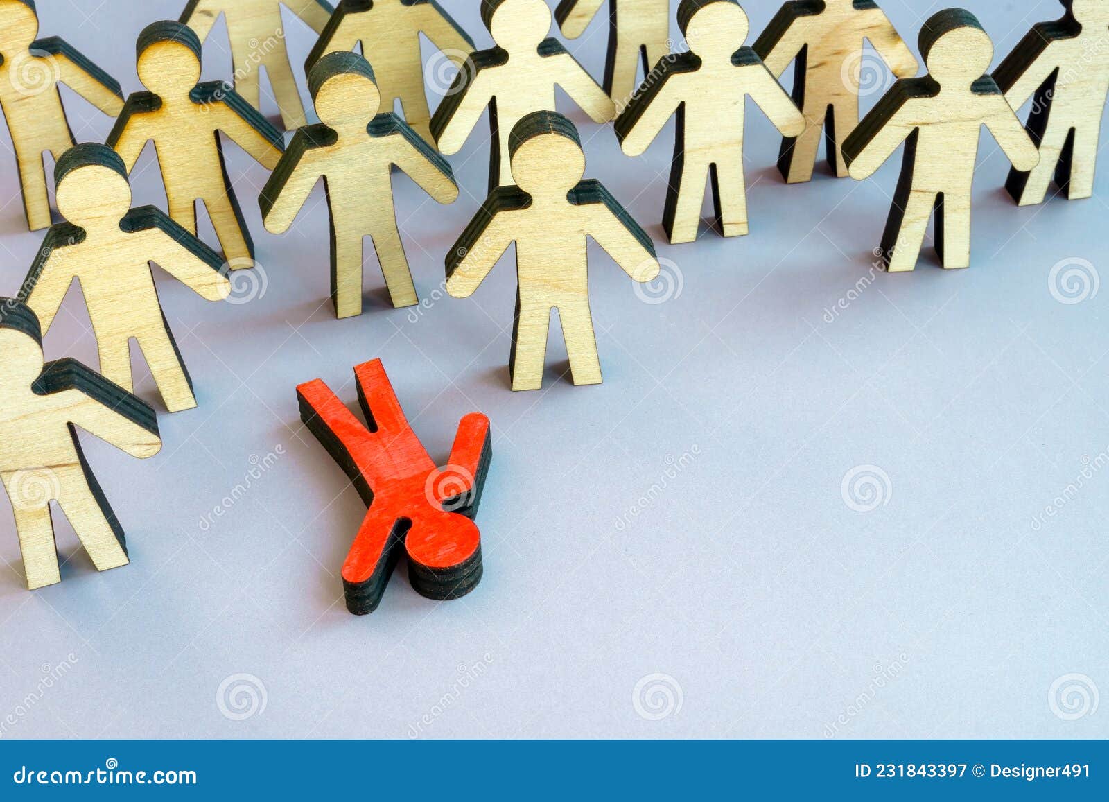 the figurine lies in the crowd. burnout at work or physical or emotional exhaustion.