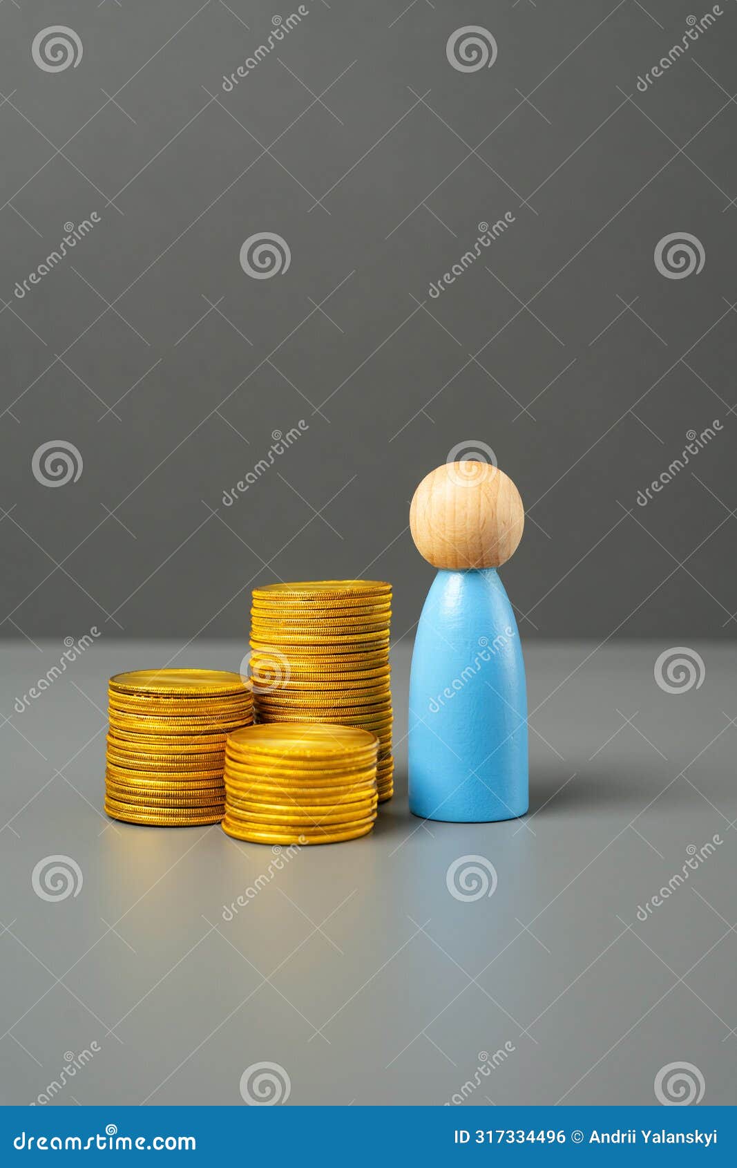 a figurine of a man and a stack of coins. savings and capital.