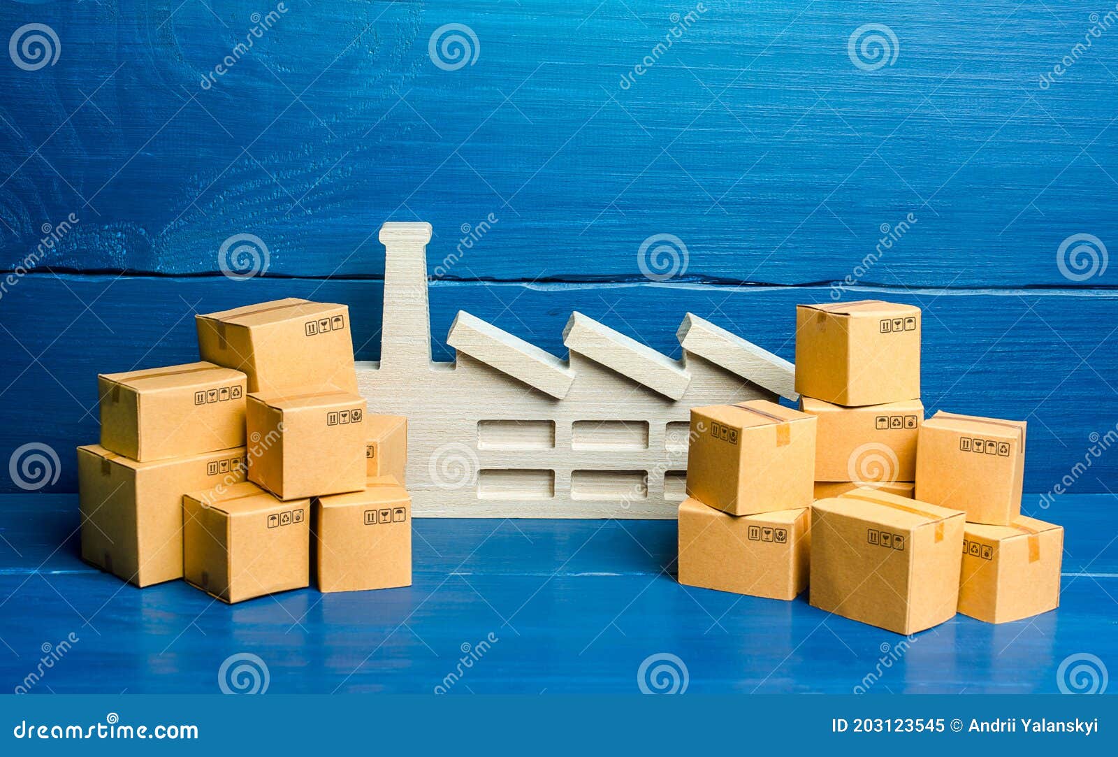 a figurine of a plant and a lot of boxes. the concept of overproduction of goods. overstocking of manufacturer`s warehouses, low