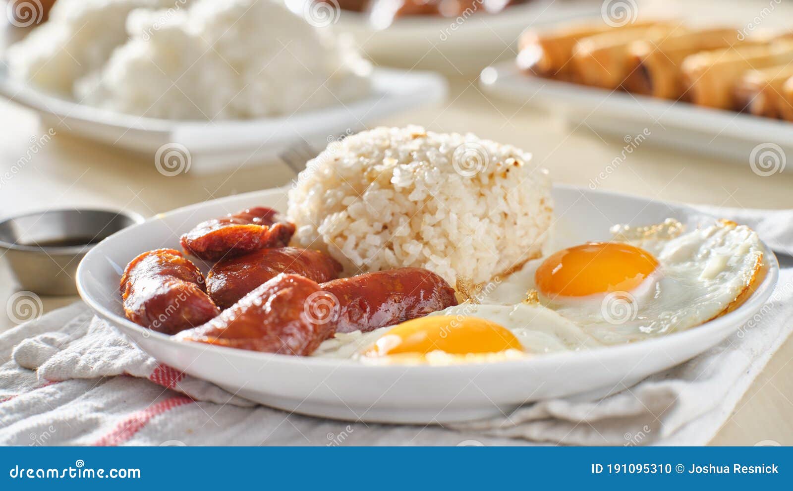 Filipino Silog Breakfast With Garlic Fried Rice, Longsilog, And Two