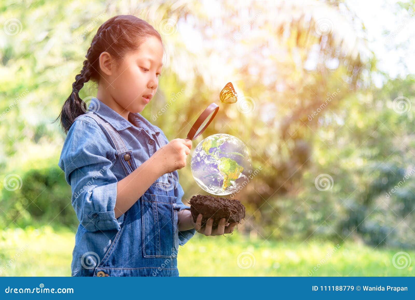 La fille asiatique tenant la loupe trouvant des usines de croissance dans le monde vert, usines consolident ambiant réduisent la terre de réchauffement global, écologie et monde de s'enregistrer L'image de la terre a fourni par la NASA