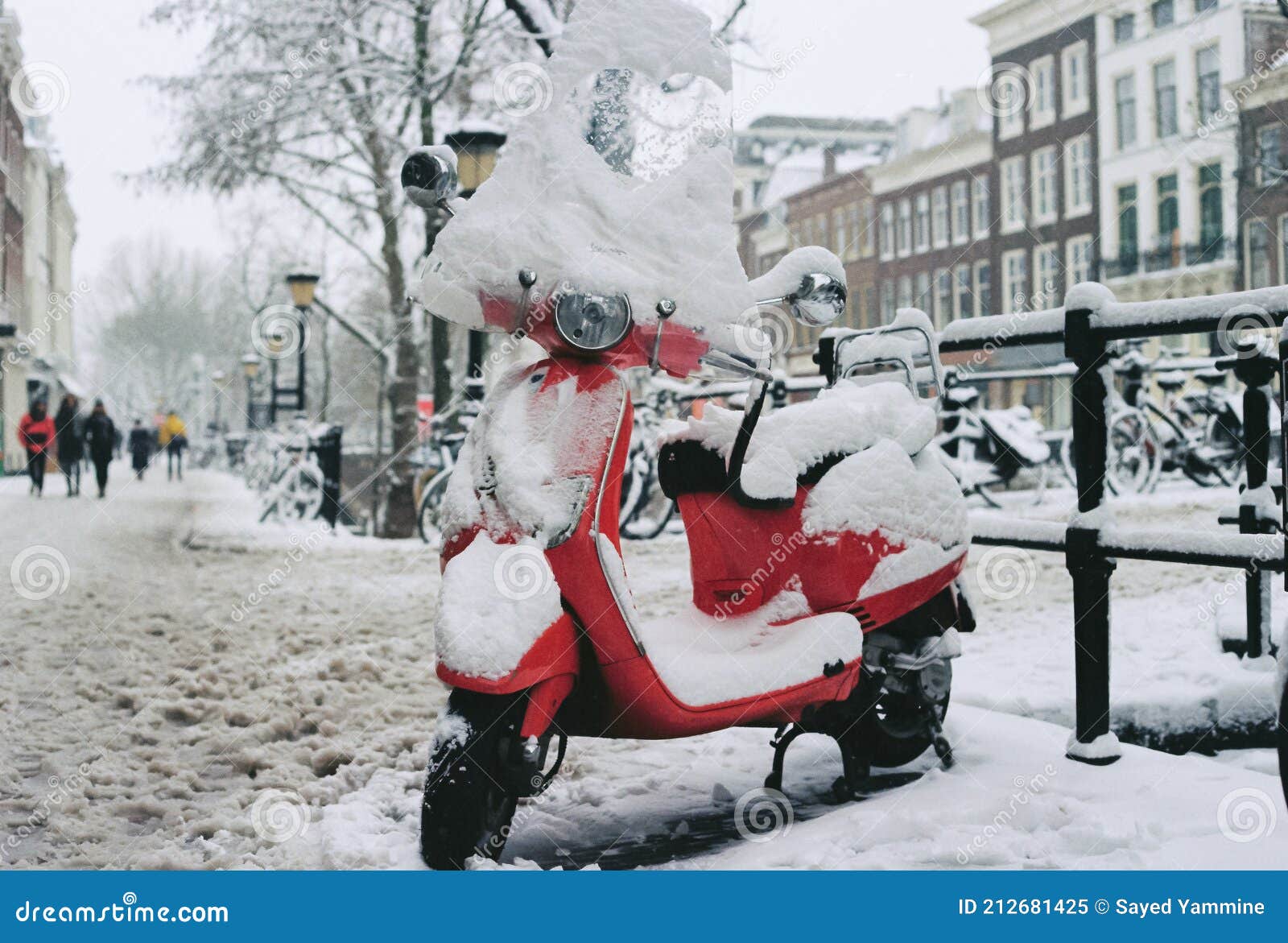 film photo of red scooter with a loveheart covered in snow in the netherlands