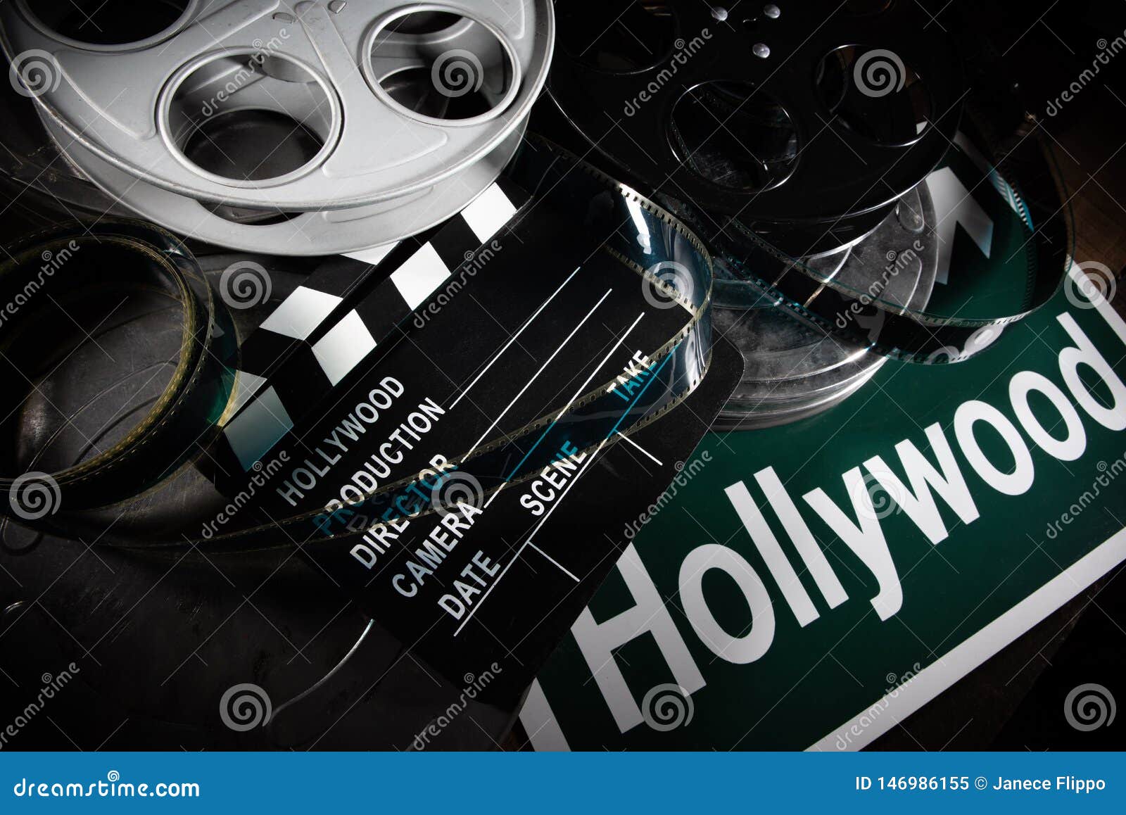 Film Reel and Clapboard. Hollywood, Entertainment Industry Background on a  Wood Table Stock Image - Image of vintage, film: 146986155