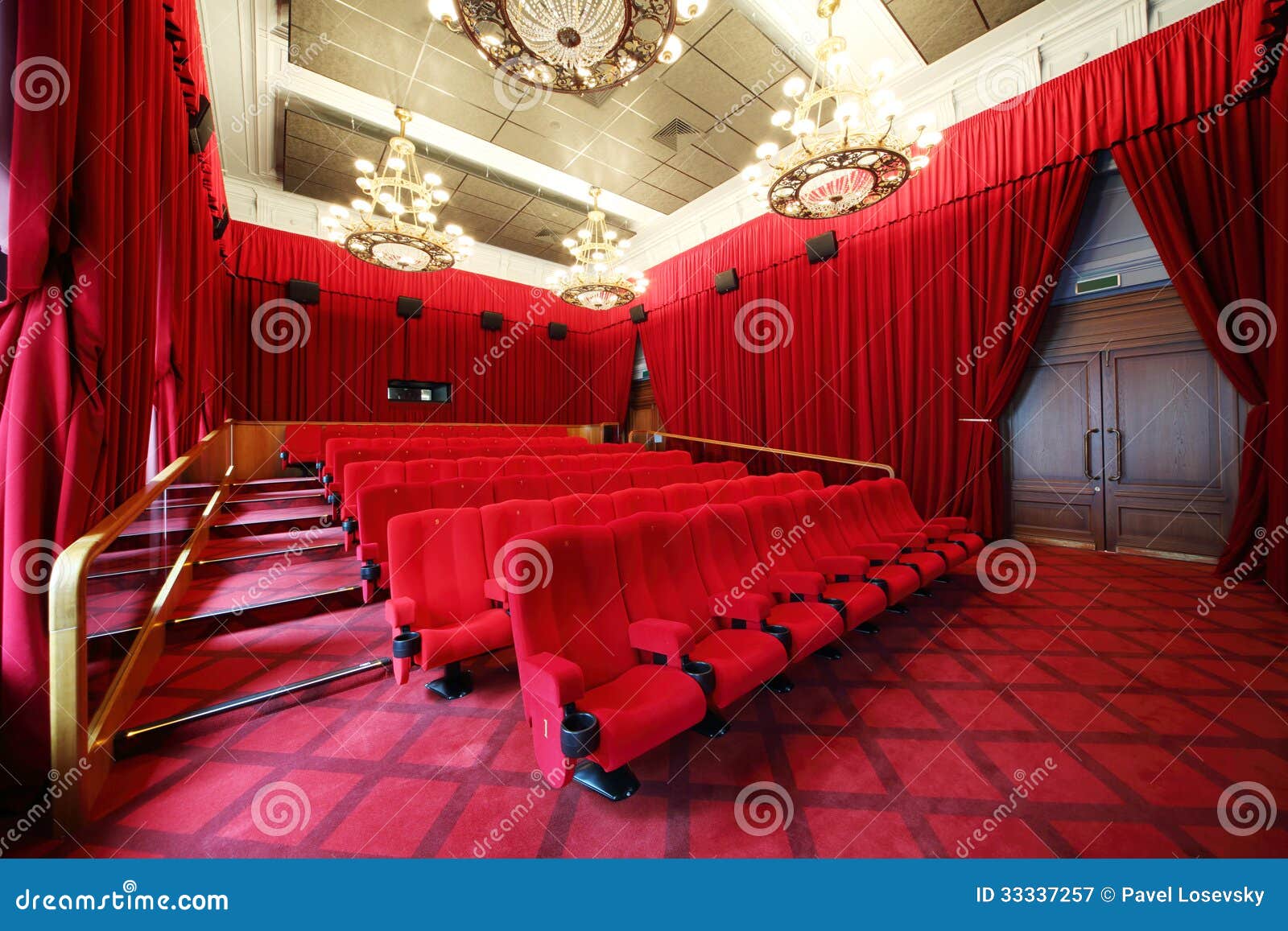 film theatre with chandeliers and rows of seats