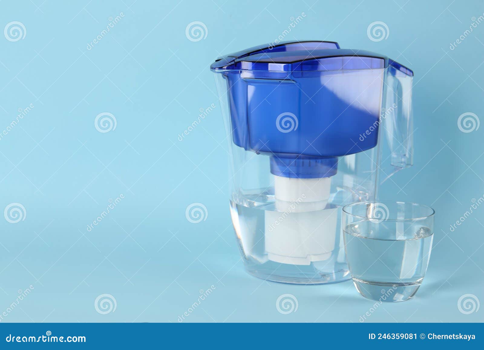 Filter Jug and Glass with Purified Water on Light Blue Background