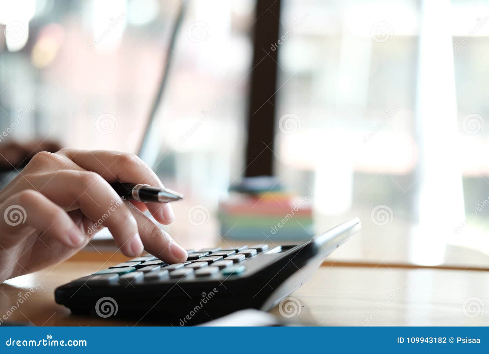 Financial Adviser Working with Calculator & Computer at Office. Stock