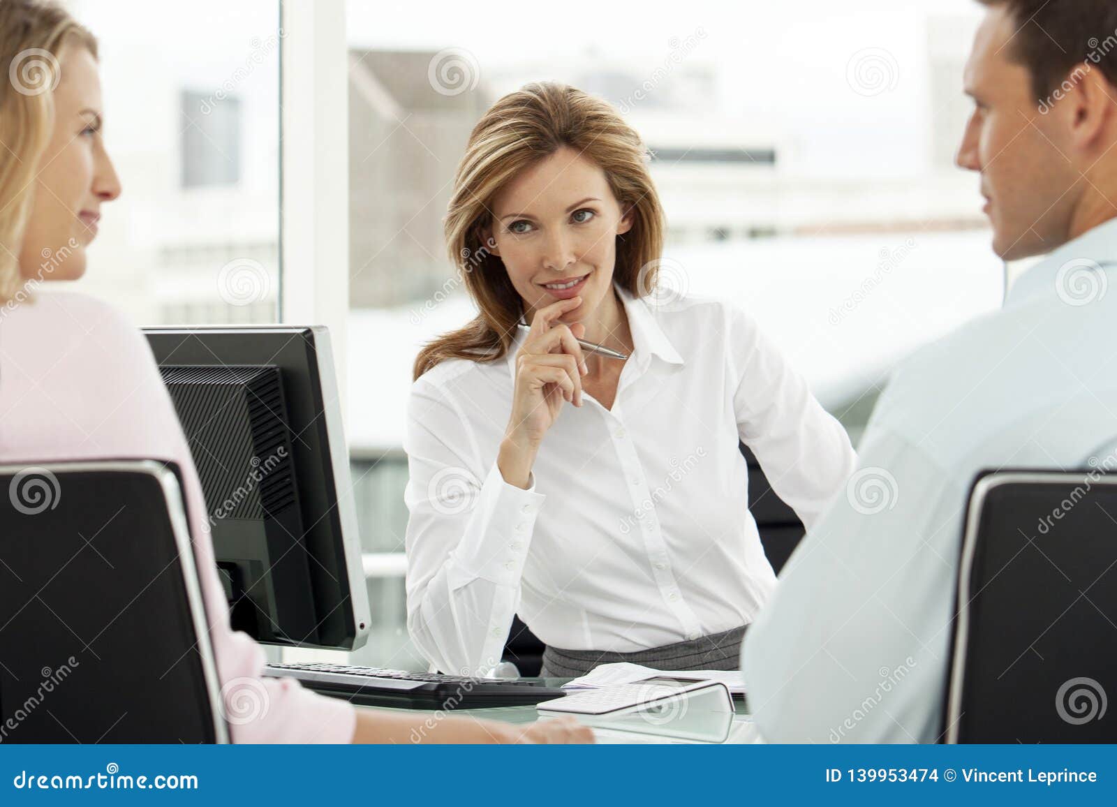 financial advisor with couple at meeting in office - lawyer providing advice to man and woman - real estate agent with clients