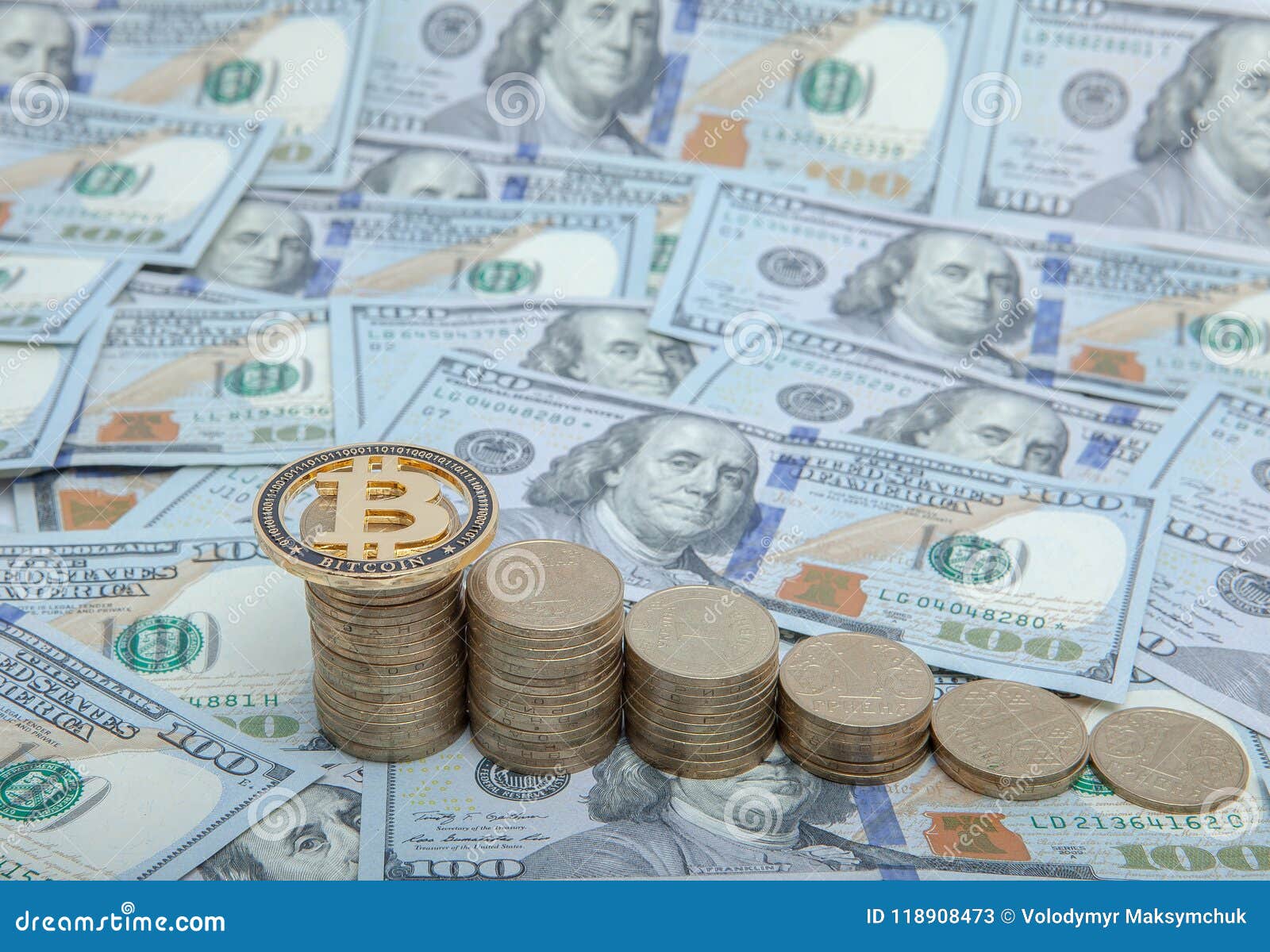financial concept image. histogram of coins and bitcoin against the background of dollars