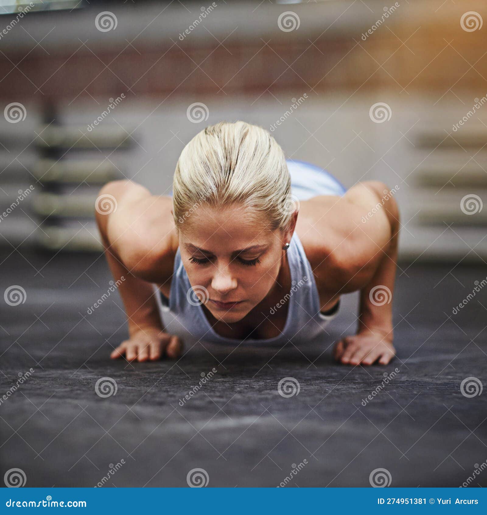 Find the Will Inside Yourself. a Young Woman Doing Pushups in a Gym