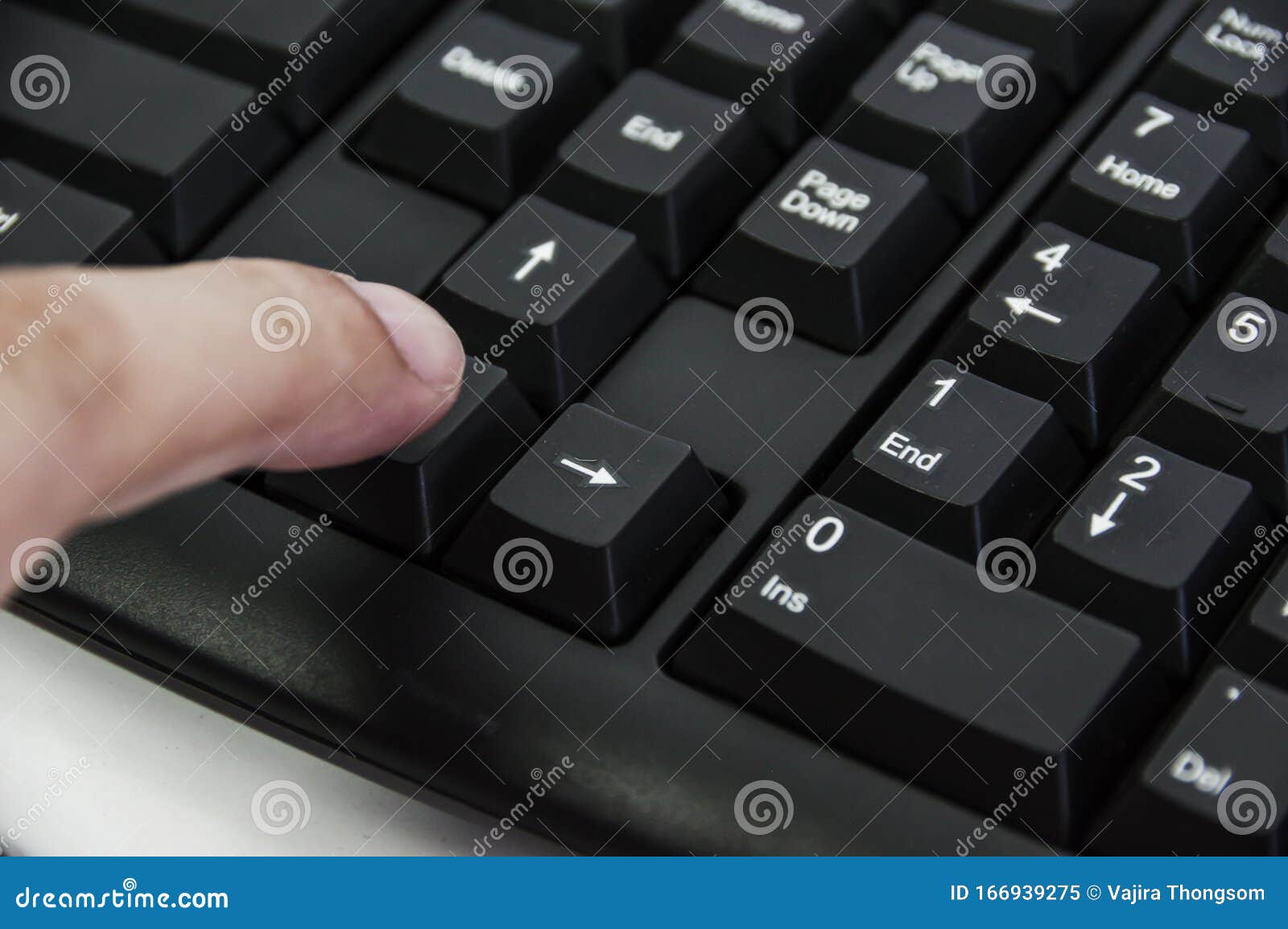 A Finger Hitting Computer Keyboard Arrow Signs on PC Keyboard Stock