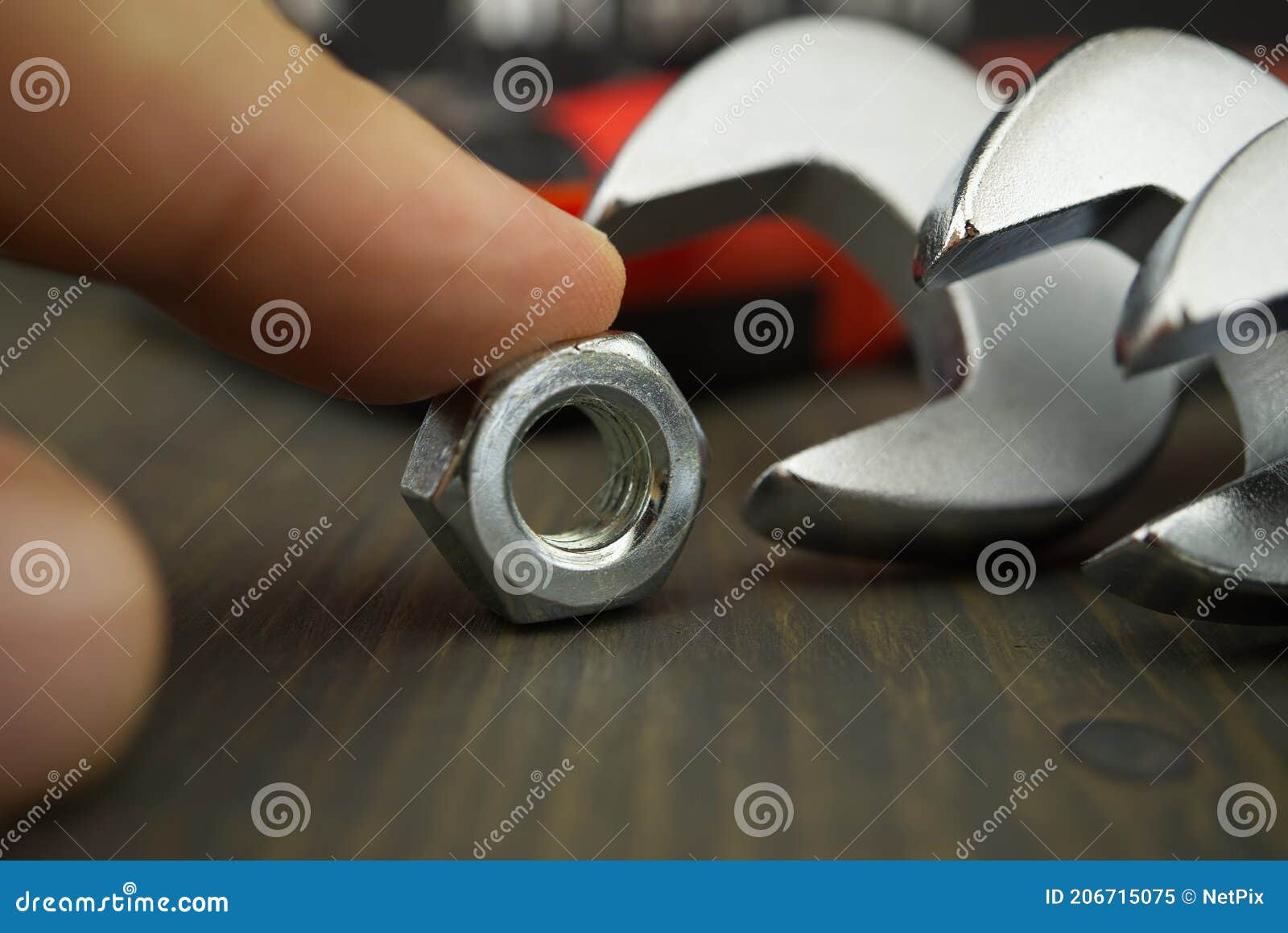 Finger Holds the Nut Next To the Wrenches Stock Image Image of chrome, maintenance 206715075