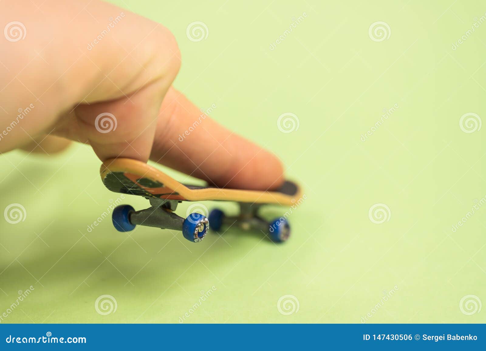 Fingerboard. Man Make Trick by Two Fingers with Small Skateboard on ...