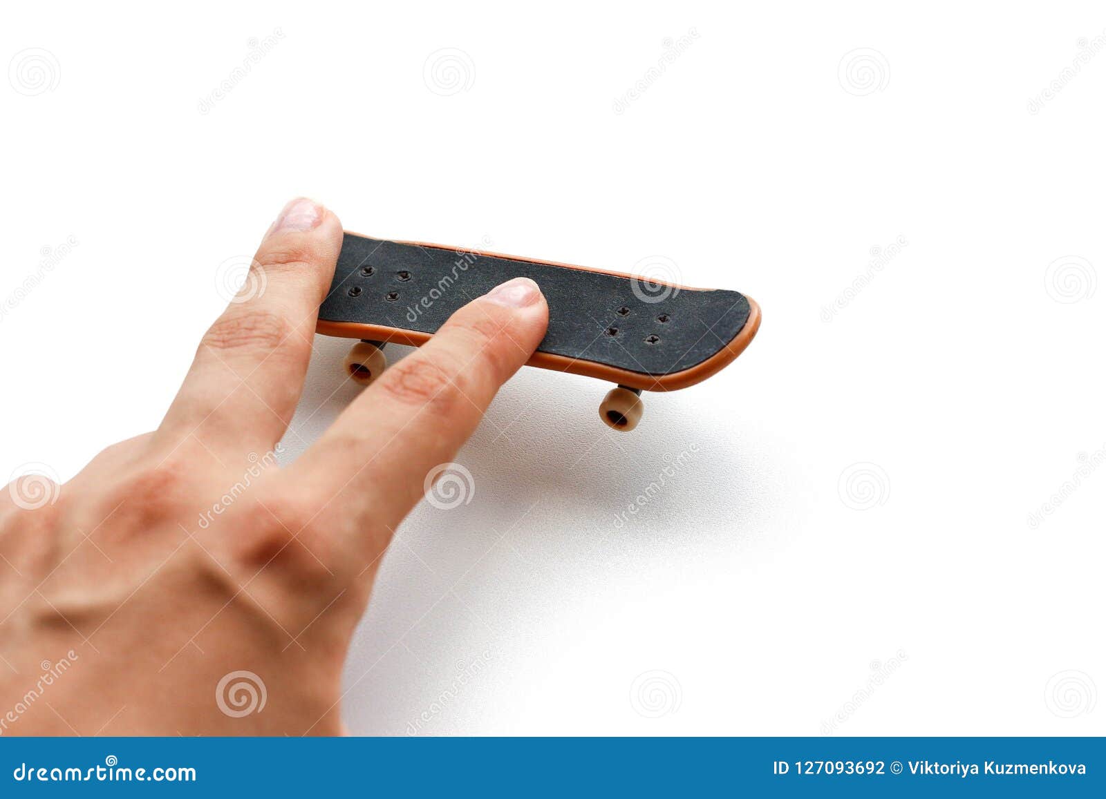 Fingerboard. a Small Skateboard and a Hand. Close Up. Isolated on White