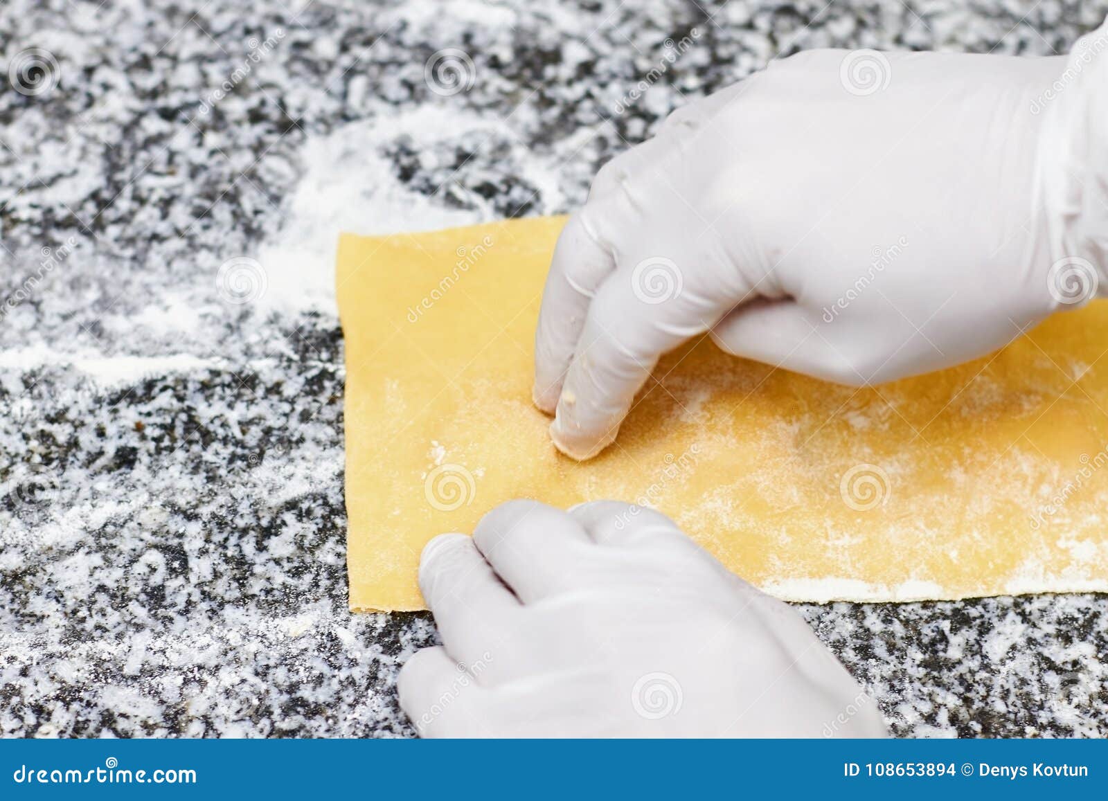 Fingers on dough sheet. stock photo. Image of glove - 108653894