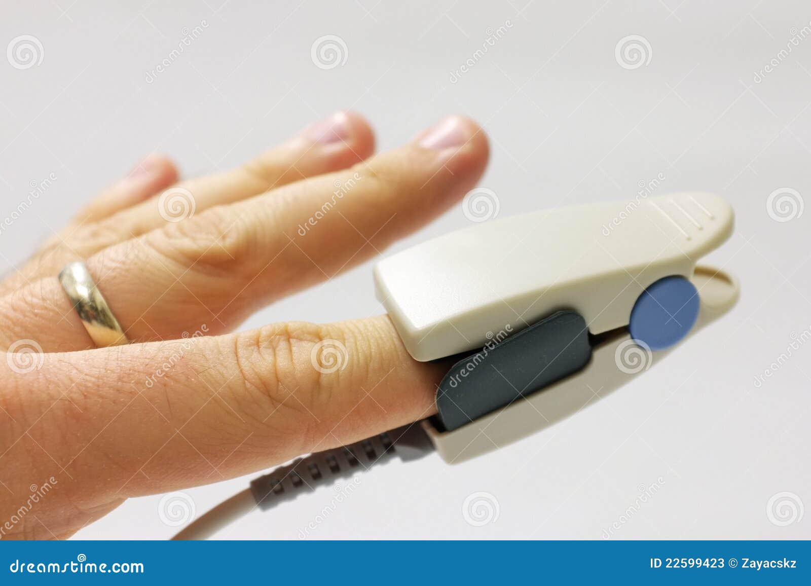 fingertip pulse oximeter sensor placed on finger