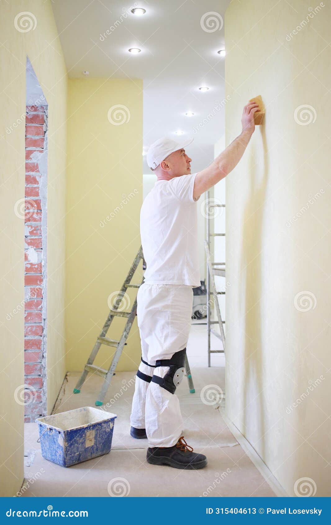 finisher polishing the wall using a sanding