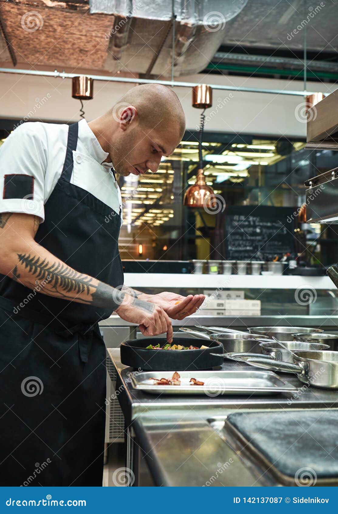 Finishing a Dish. Side View of Young Male Chef with Several Tattoos on His Arms Garnishing Italian Pasta Stock Image - Image of herb, macaroni: 142137087 Finishing a Dish. Side View of Young Male Chef with Several Tattoos on His Arms Garnishing Italian Pasta Stock Image - Image of herb, macaroni: 142137087