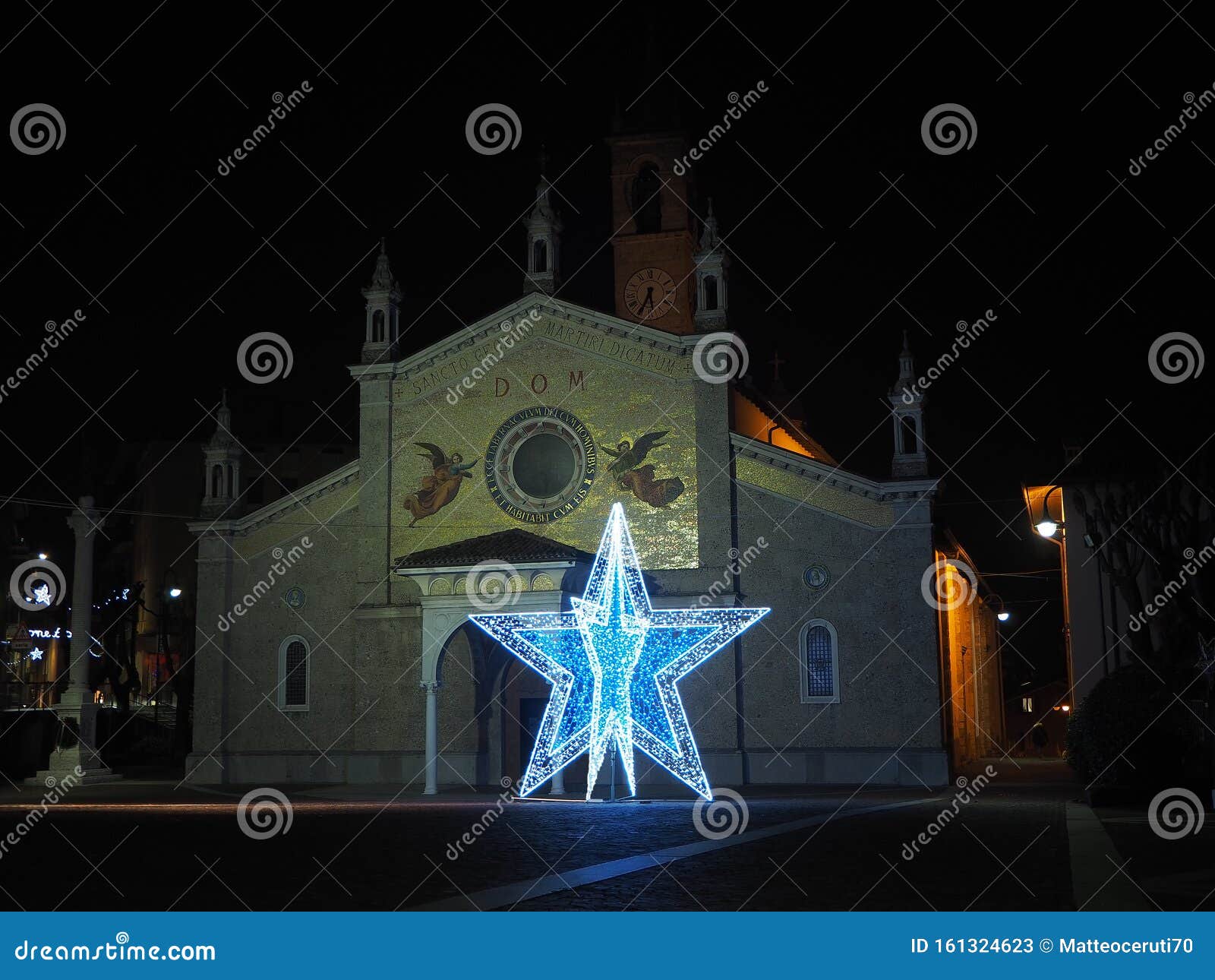 fiorano al serio, bergamo, italy. the main church of saint giorgio with a big illuminated christmas star during the christmas time