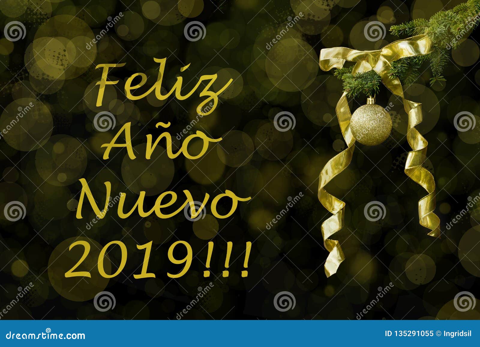 fir tree branch with golden glitter ball and ribbon on dark background. bokeh effects. new year greetings postcard feliz aÃÂ±o
