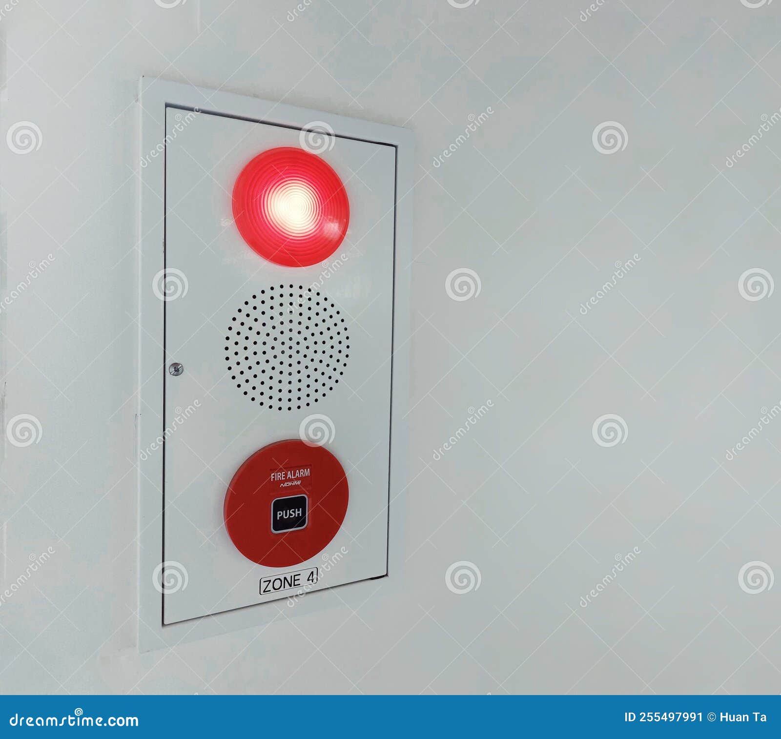 A Fire Alarm White Panel with Emergency Fire Push Button in Red a
