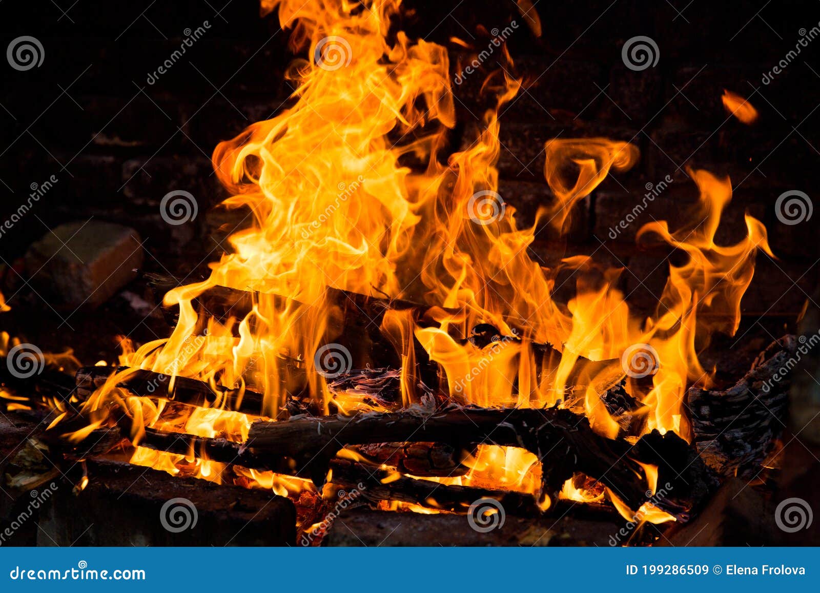 Fire Burning in a Brick Fireplace. Red and Yellow Flames Stock Image