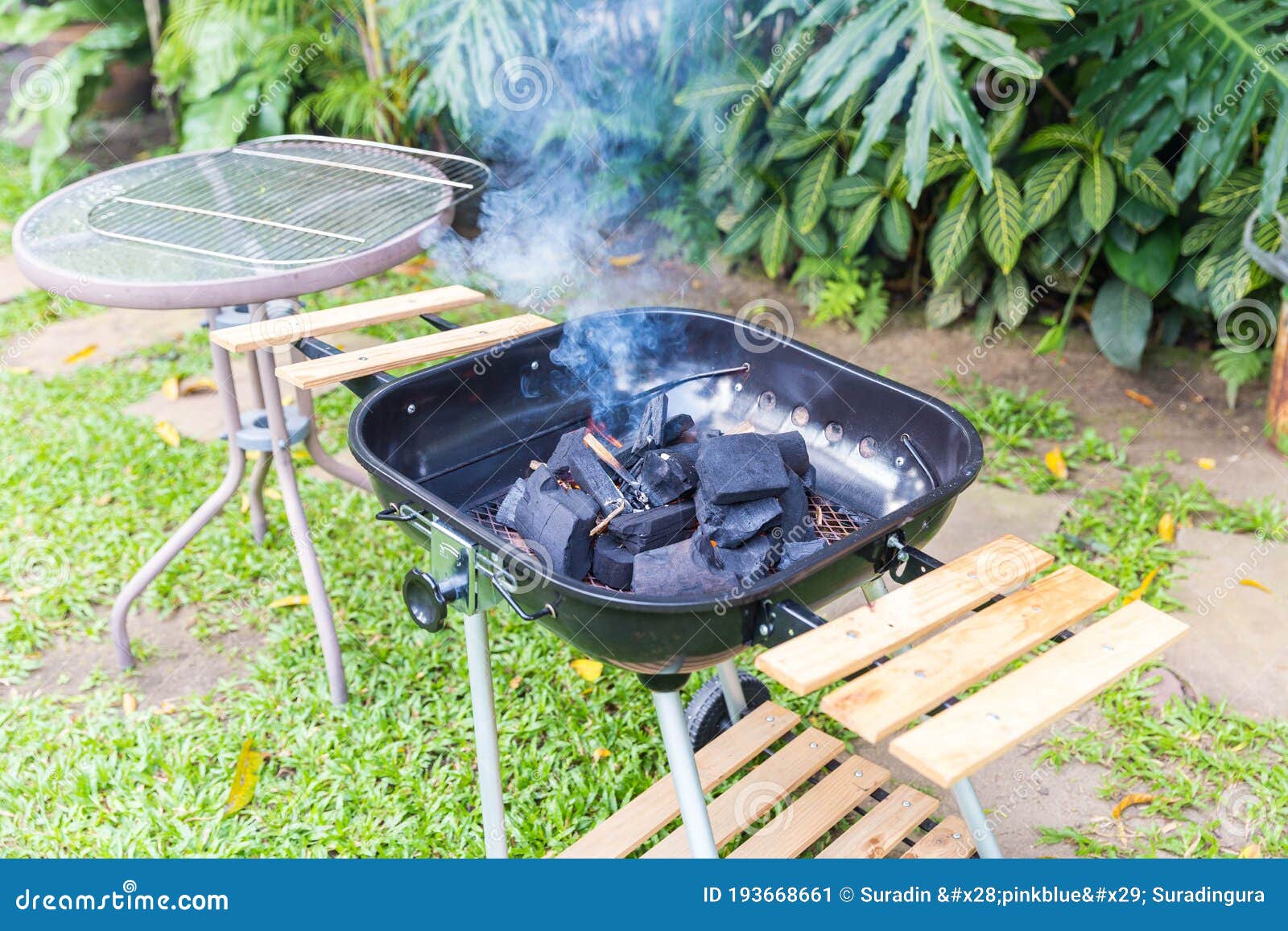 Fire Coal in Barbecue Grill Ready for Cook in an Outdoor Backyard Stock