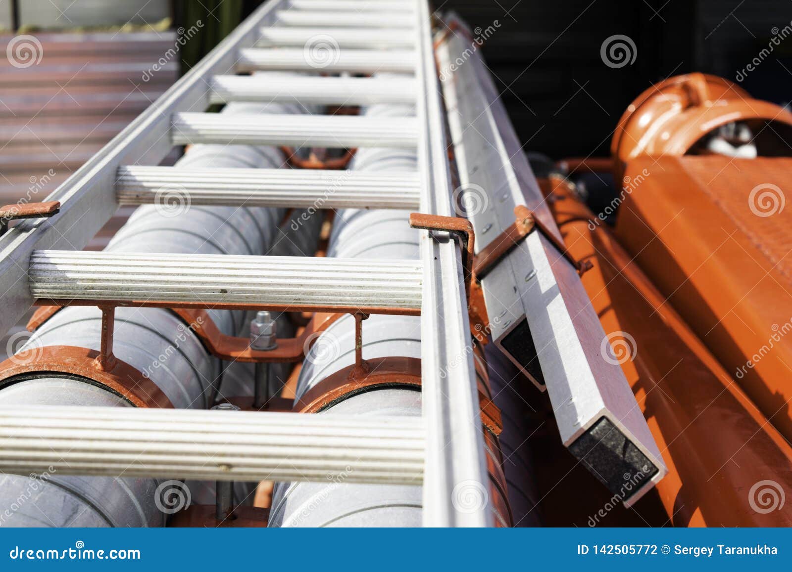 Fire Escape and Ladder Lie on Fire Engine on the Brackets Stock Photo