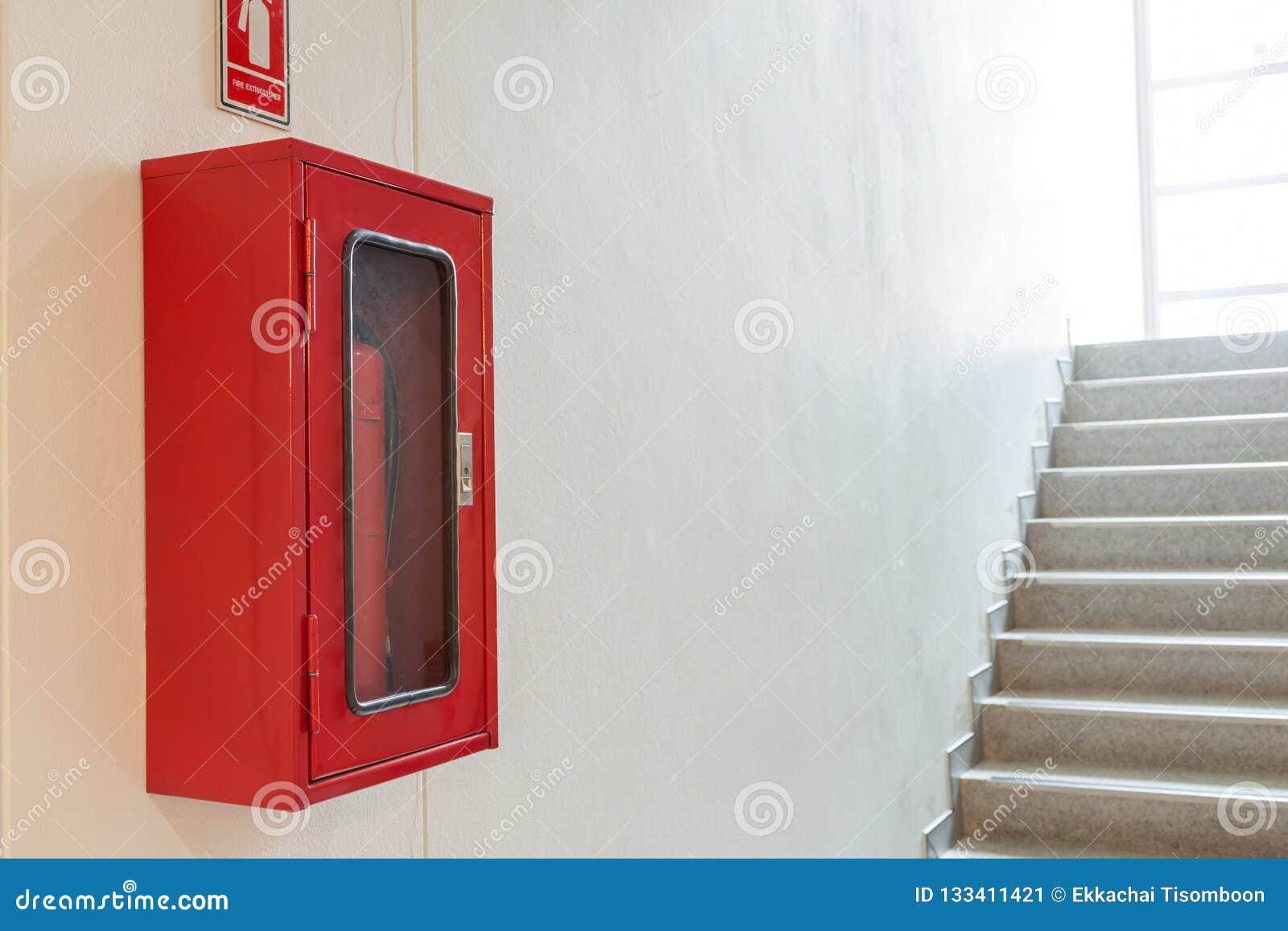 Fire Extinguisher Cabinet On White Wall Near Staircase Stock Image