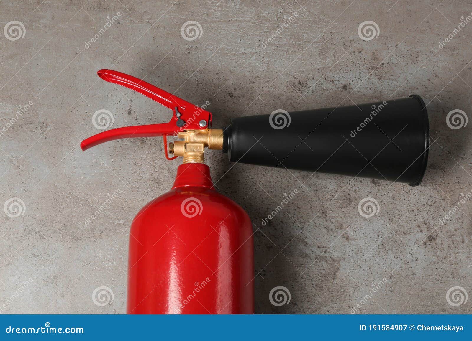 Fire Extinguisher on Grey Stone Background, Top View Stock Image