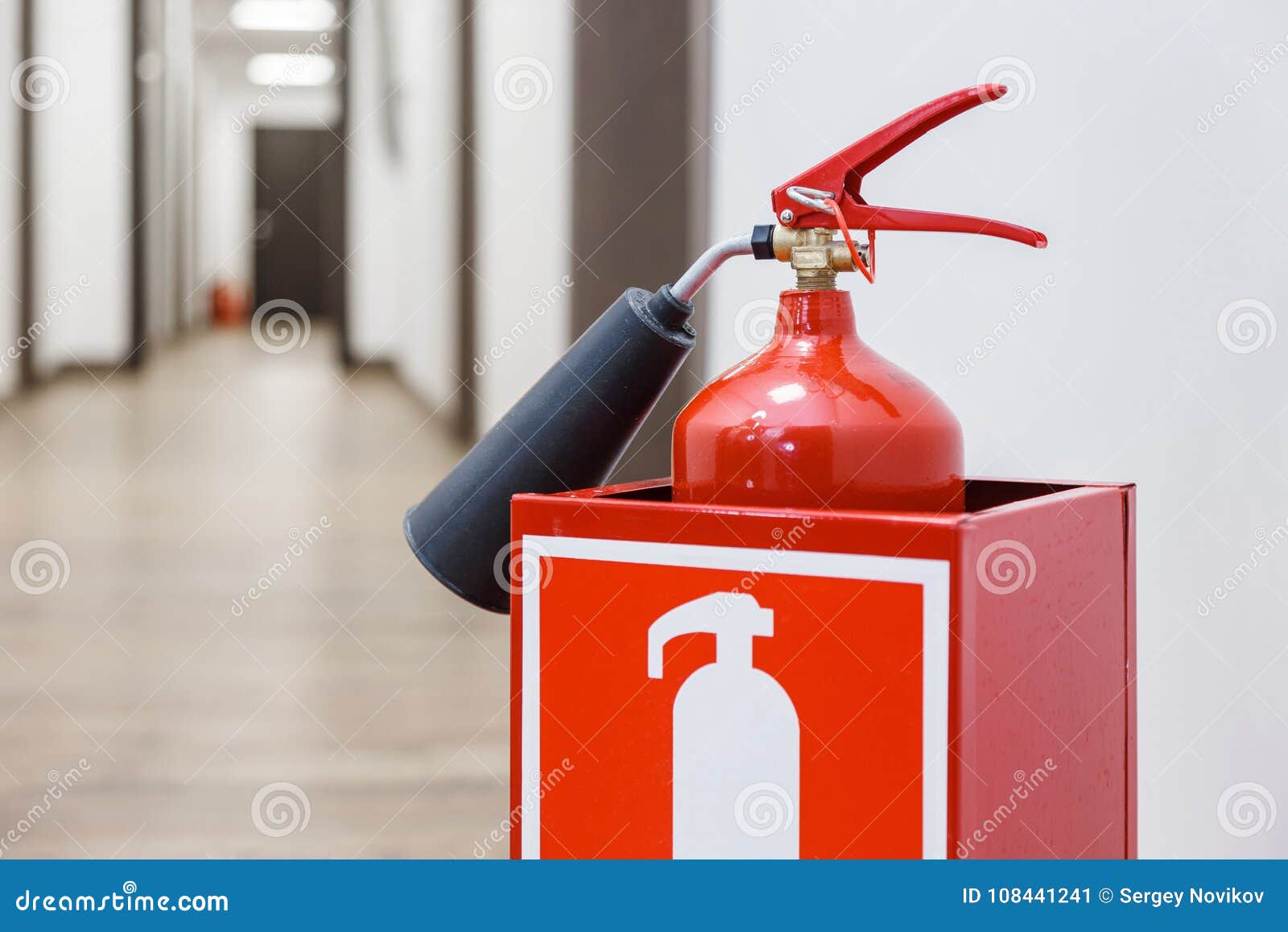 Fire Extinguisher in White Corridor of Business Center Stock Image