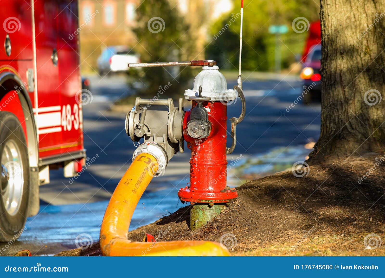 Fire Hydrant Water Supply during Emergency Hooked To Hose Stock Photo