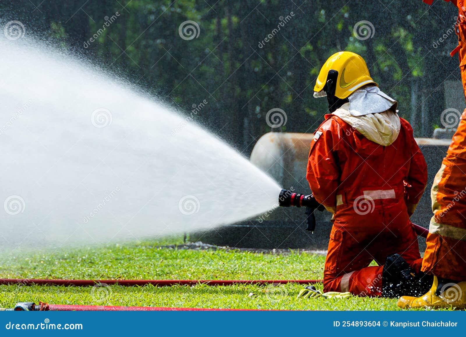 firefighter fighting fire with hose