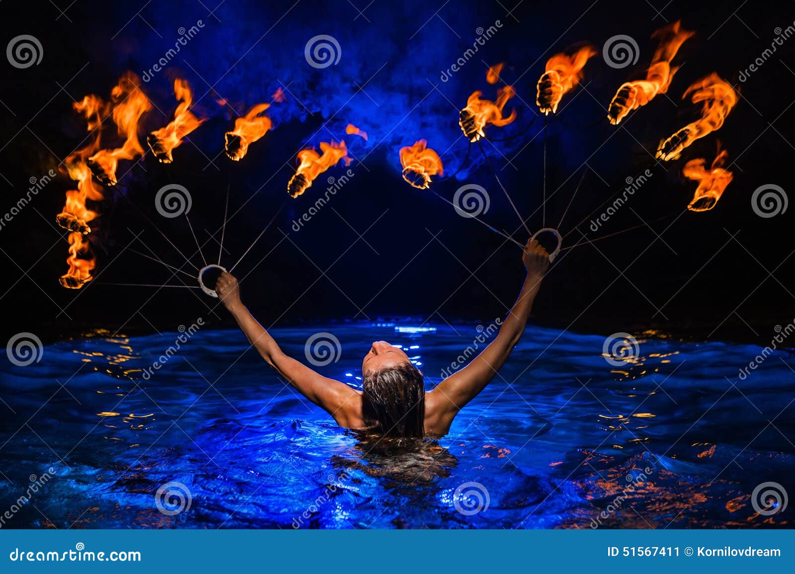 Firedancer. Sexy Woman Perform Fire Tricks In Darkness. Fire