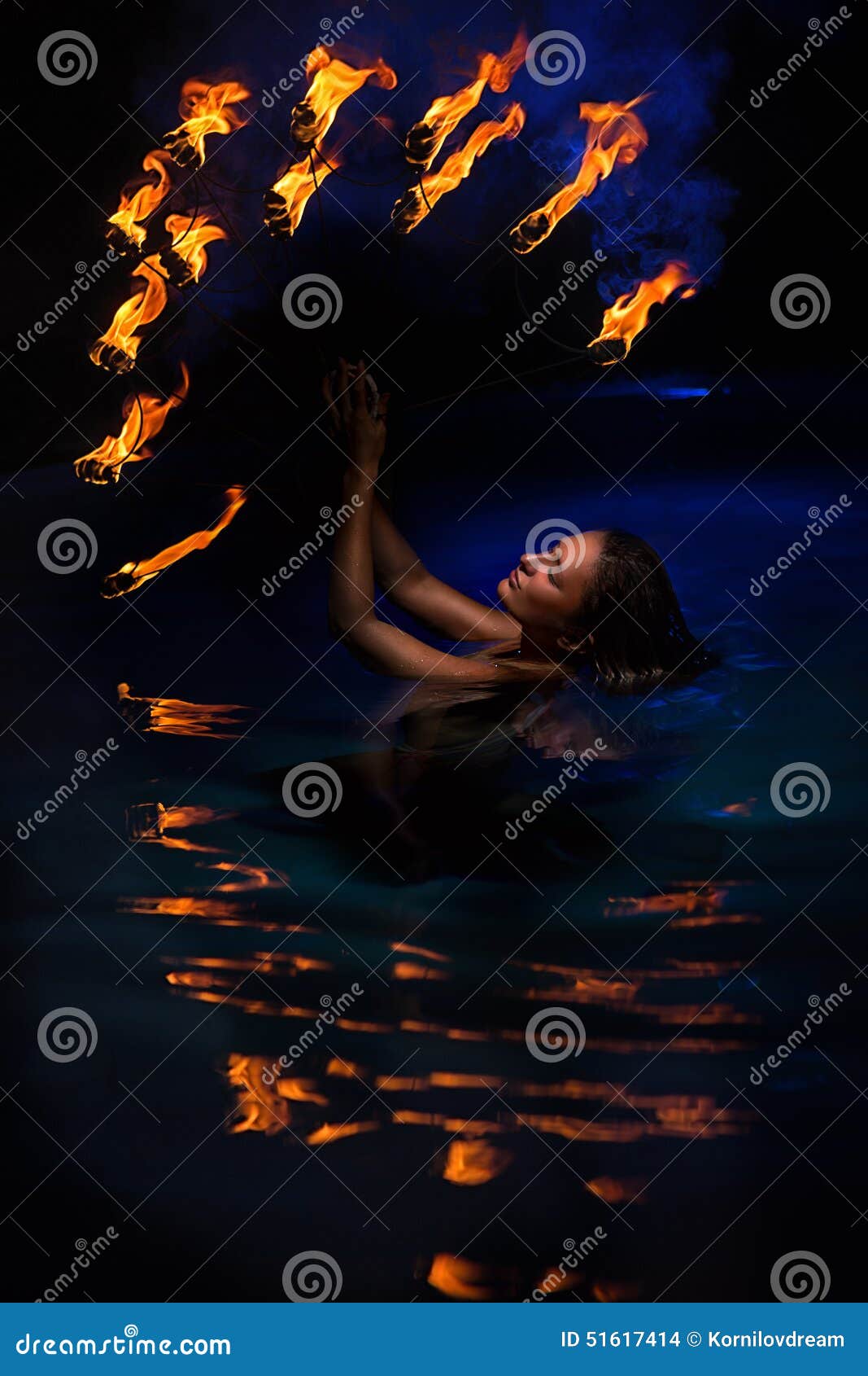 Firedancer. Sexy Woman Perform Fire Tricks In Darkness. Fire