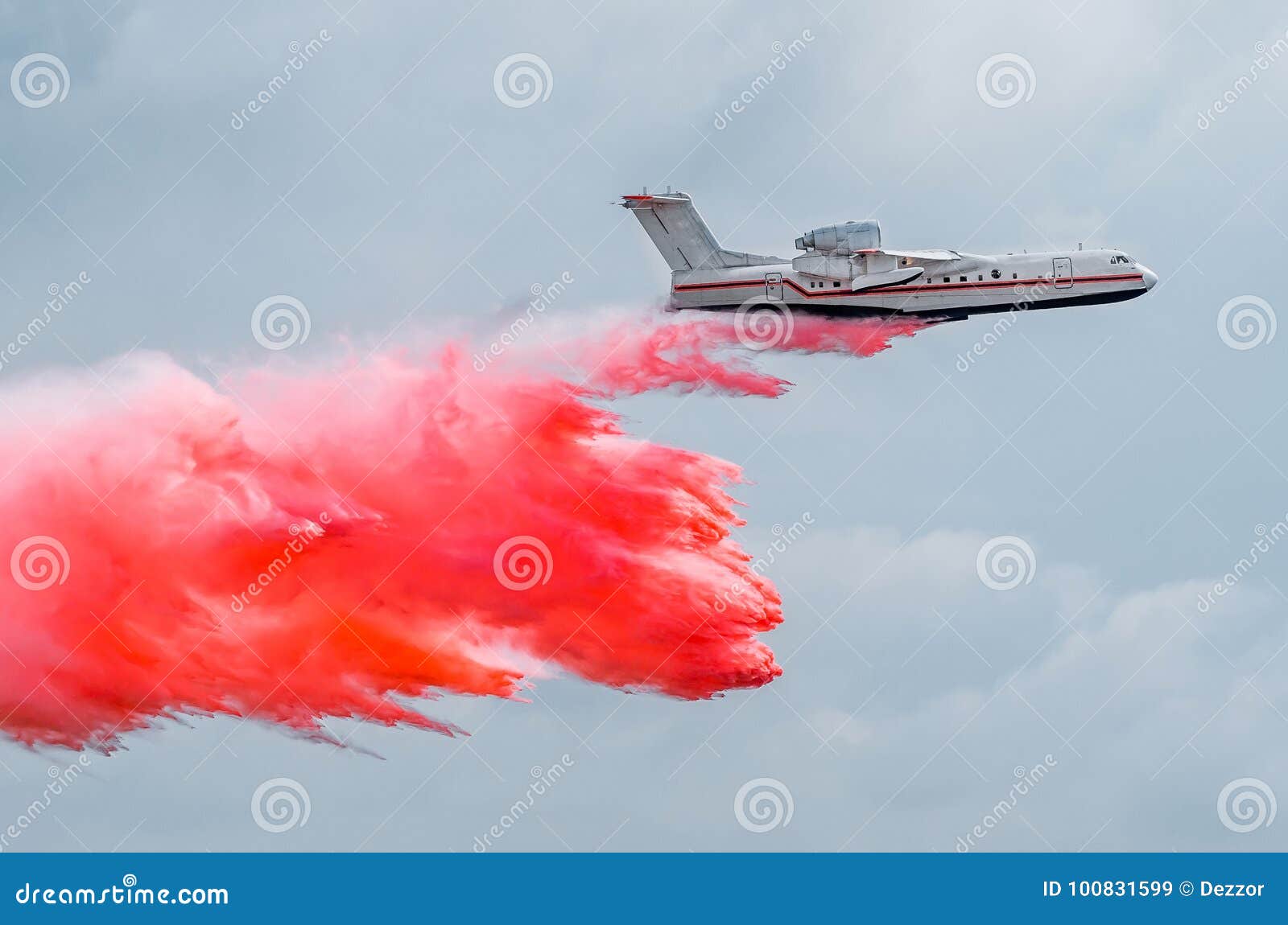 Firefighter Airplane Drops Red Water on a Fire in the Forest. Stock
