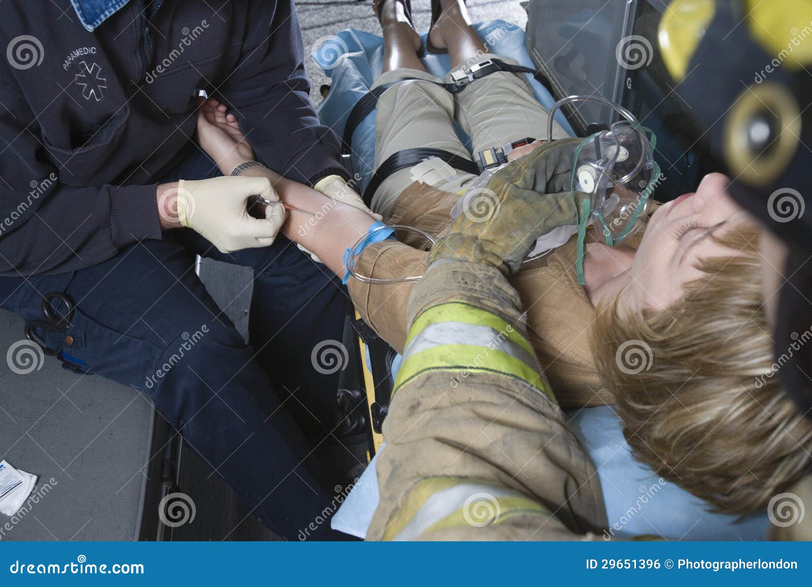 firefighter and emt doctor helping an injured patient