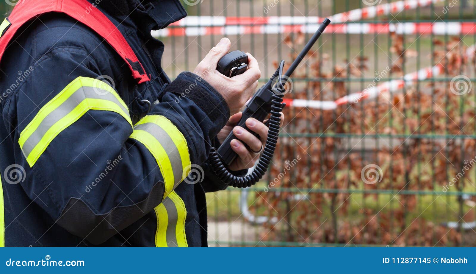 firefighter operate with a walkie talkie in action - serie firefighter