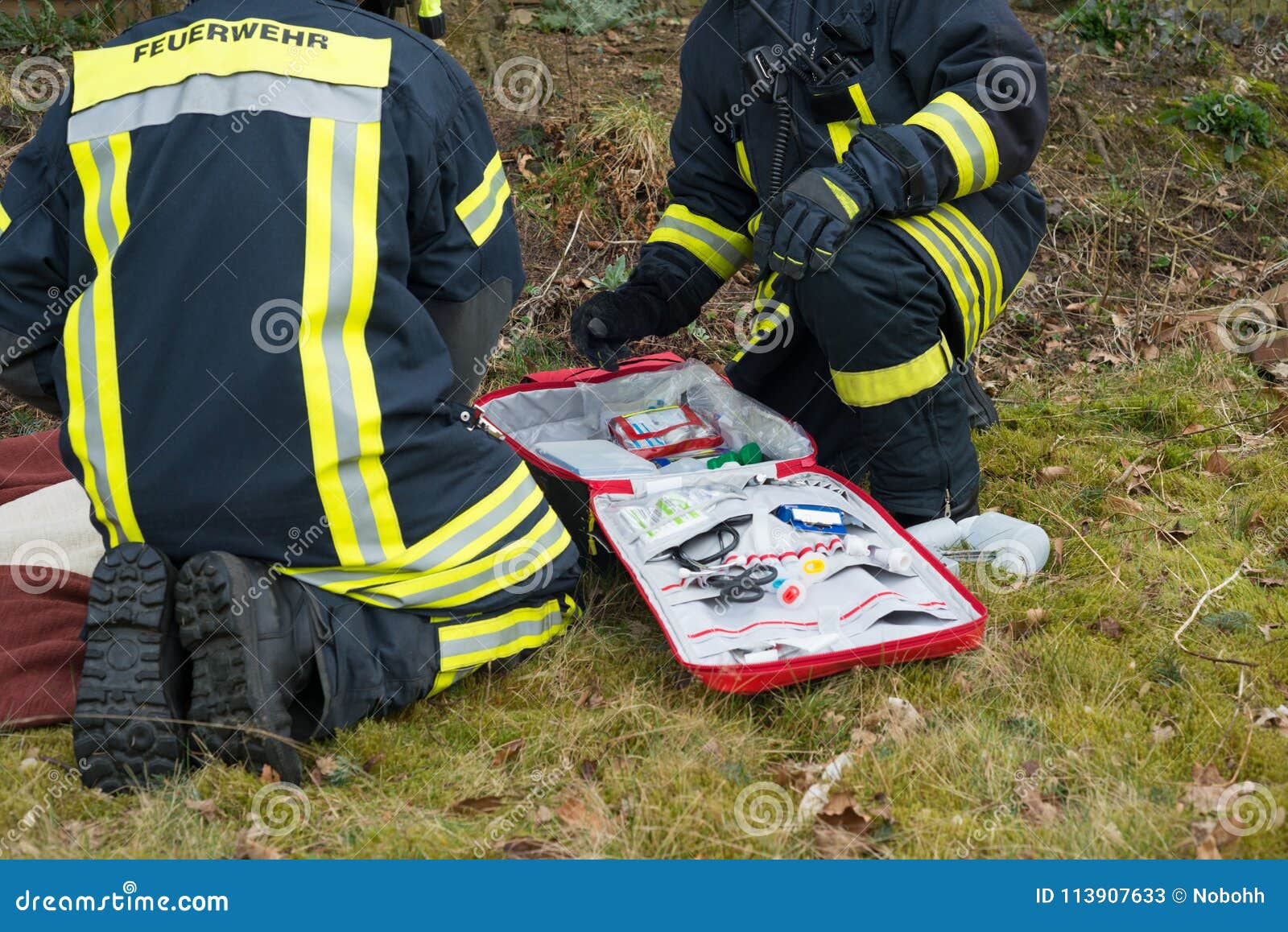Firefighter in Use with First Aid Kit Serie Firefighter Stock Image