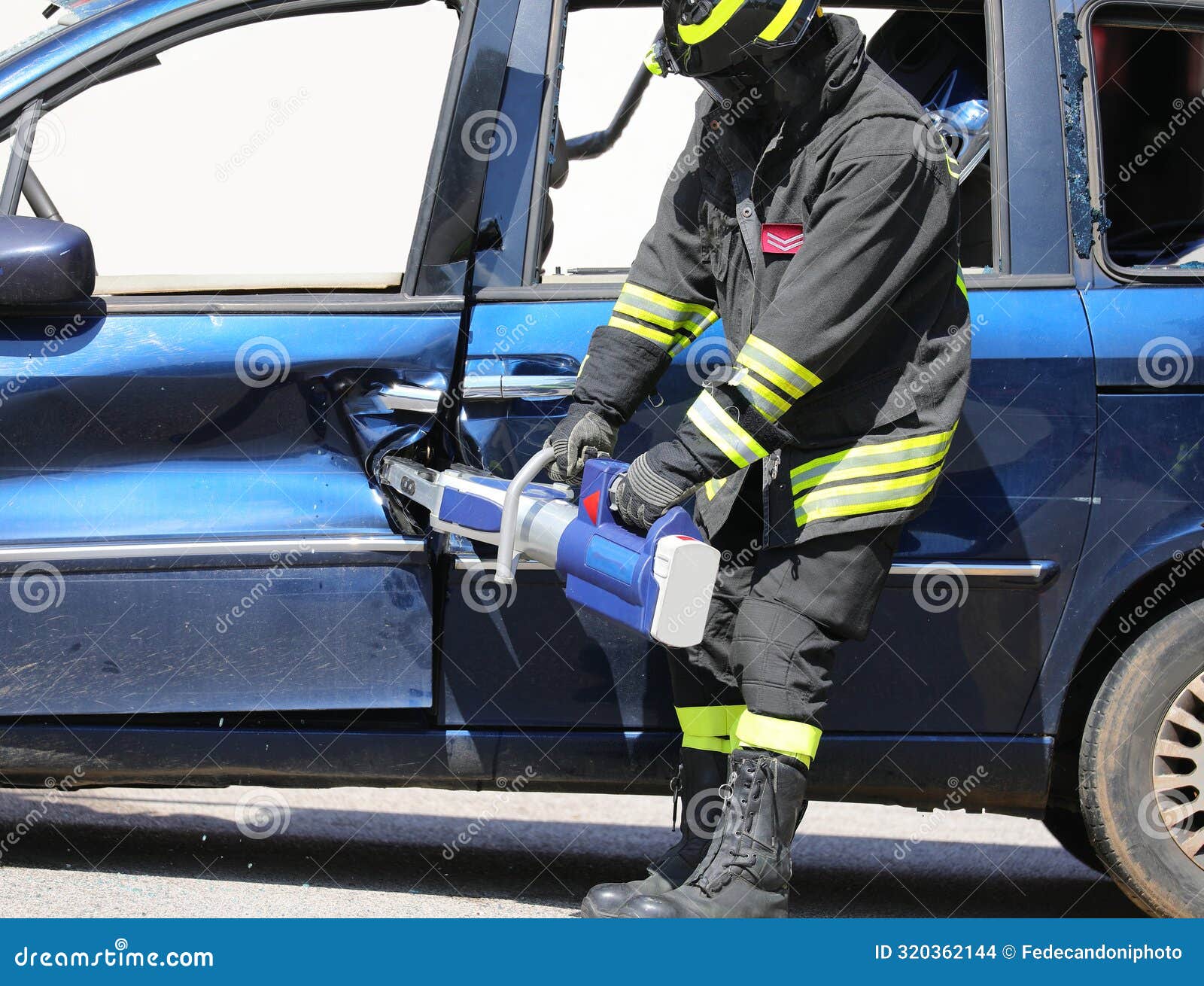 Firefighter Using Powerful Pneumatic Shears To Open the Jammed Door of