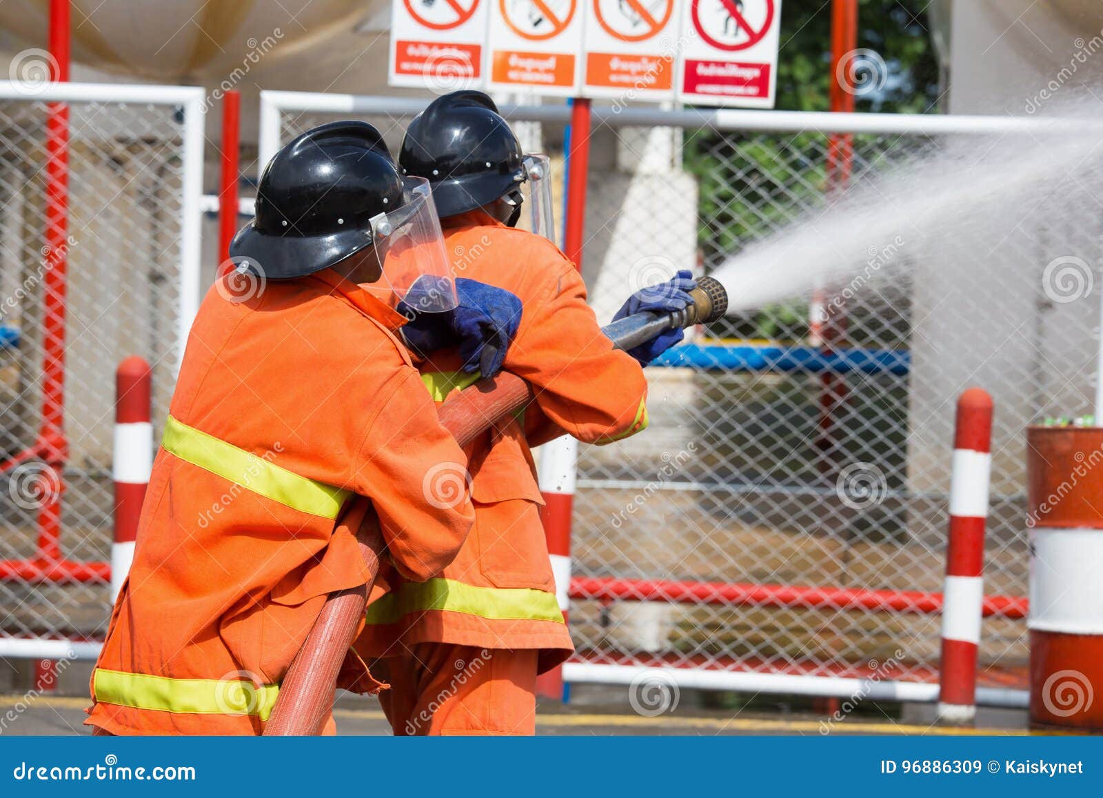 Firefighters Spray Water in LPG Gas Tanks, Fire Extinguishers Ca Stock