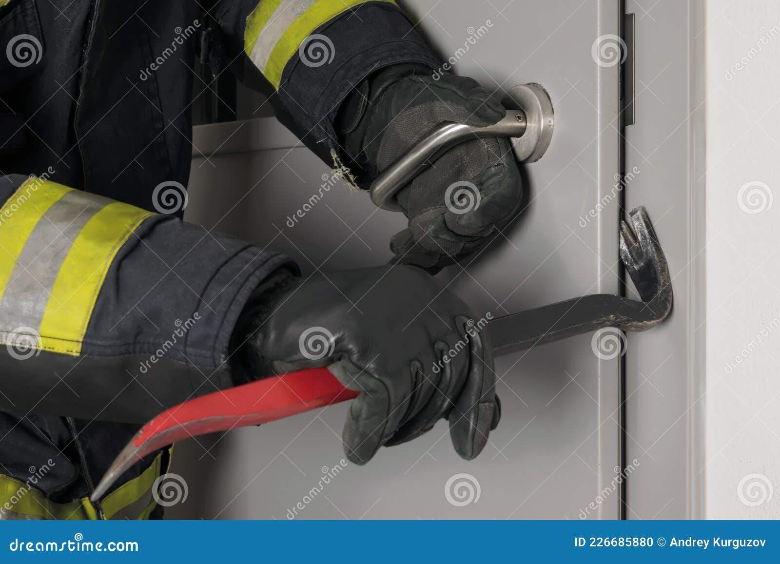 the fireman`s hands open the closed door with a special tool