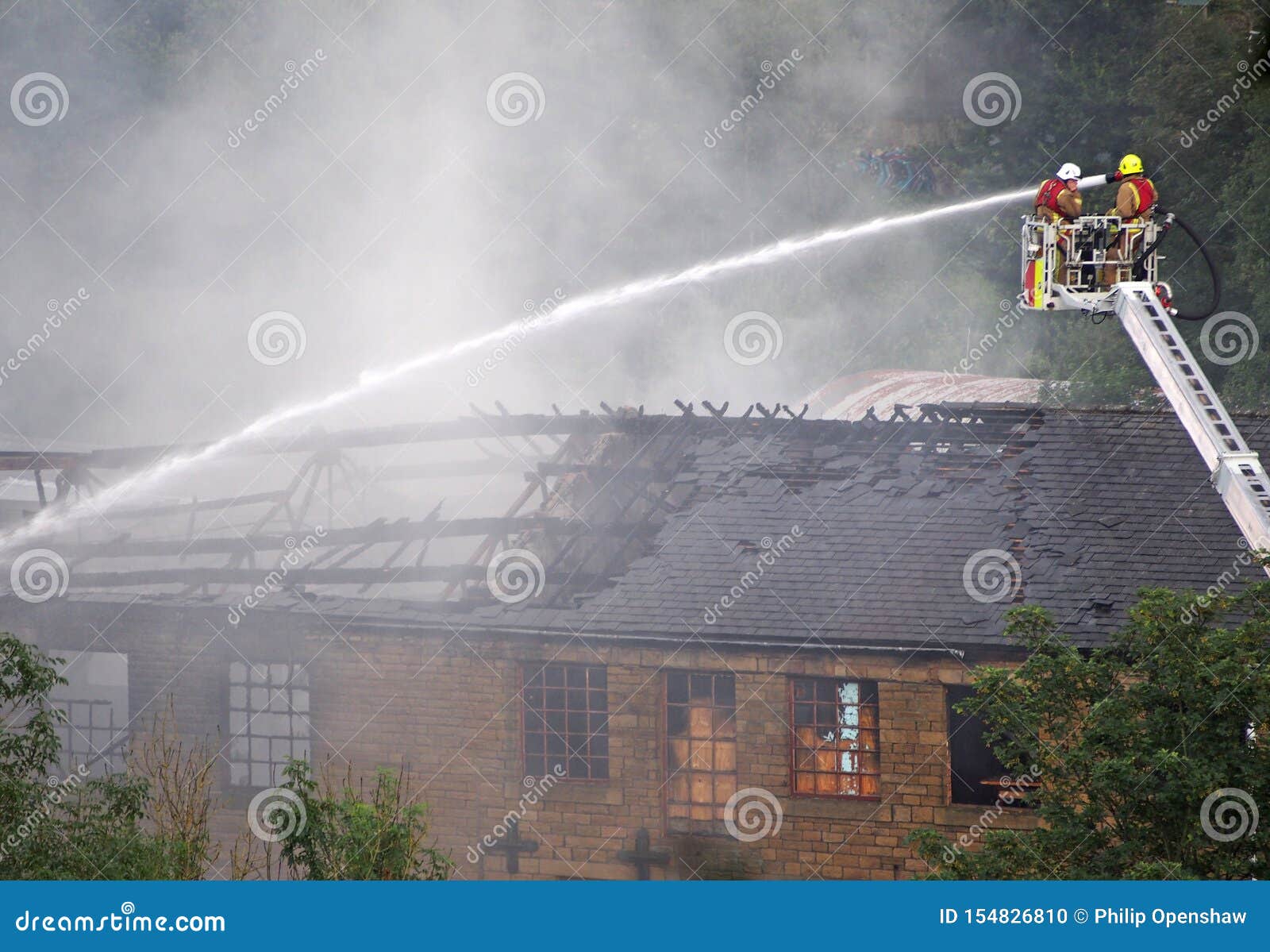 Firemen on an Elevated Platform Putting Out the Fire at the Former ...