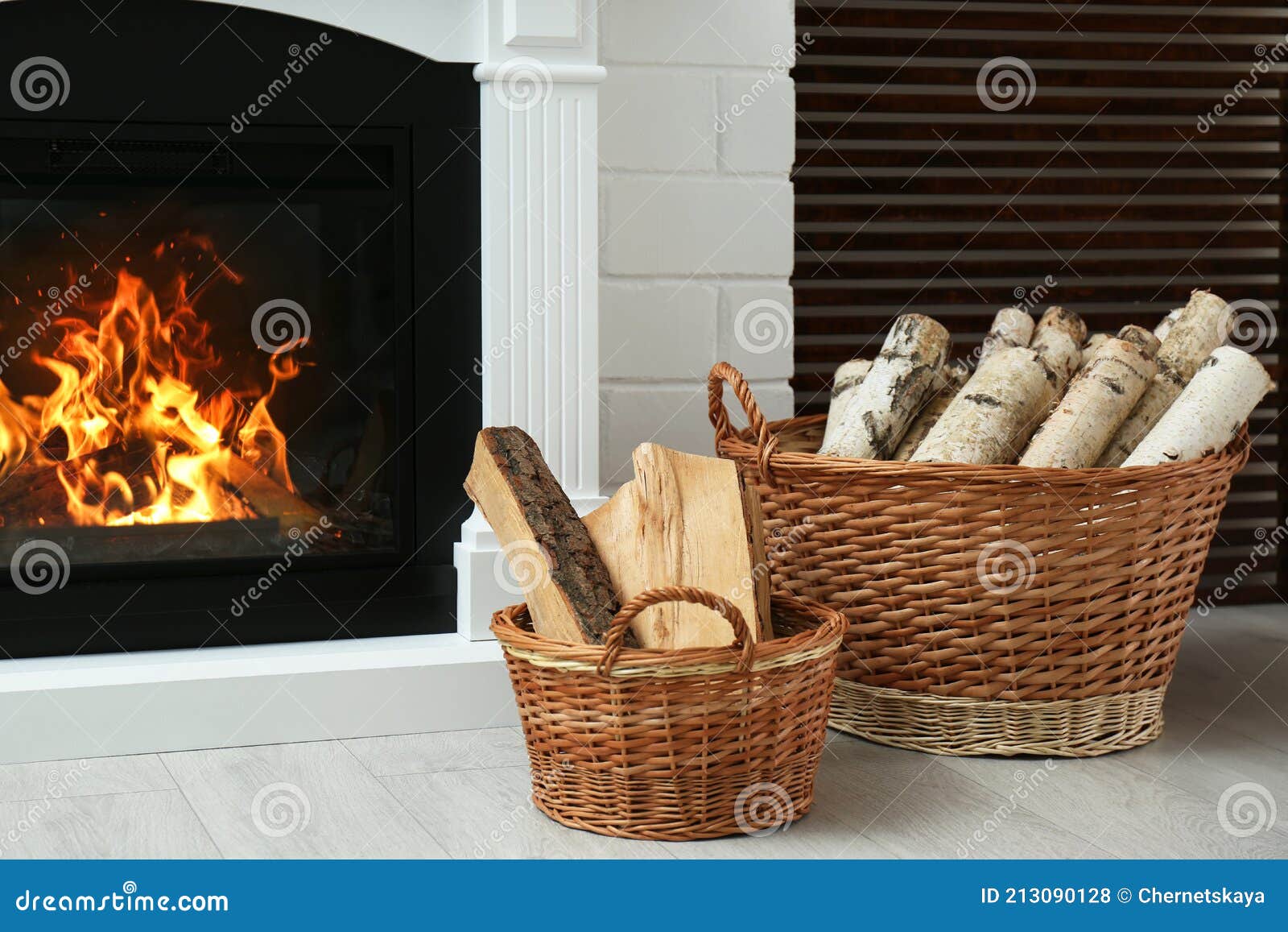 Firewood in Wicker Baskets Near Fireplace Indoors Stock Photo Image