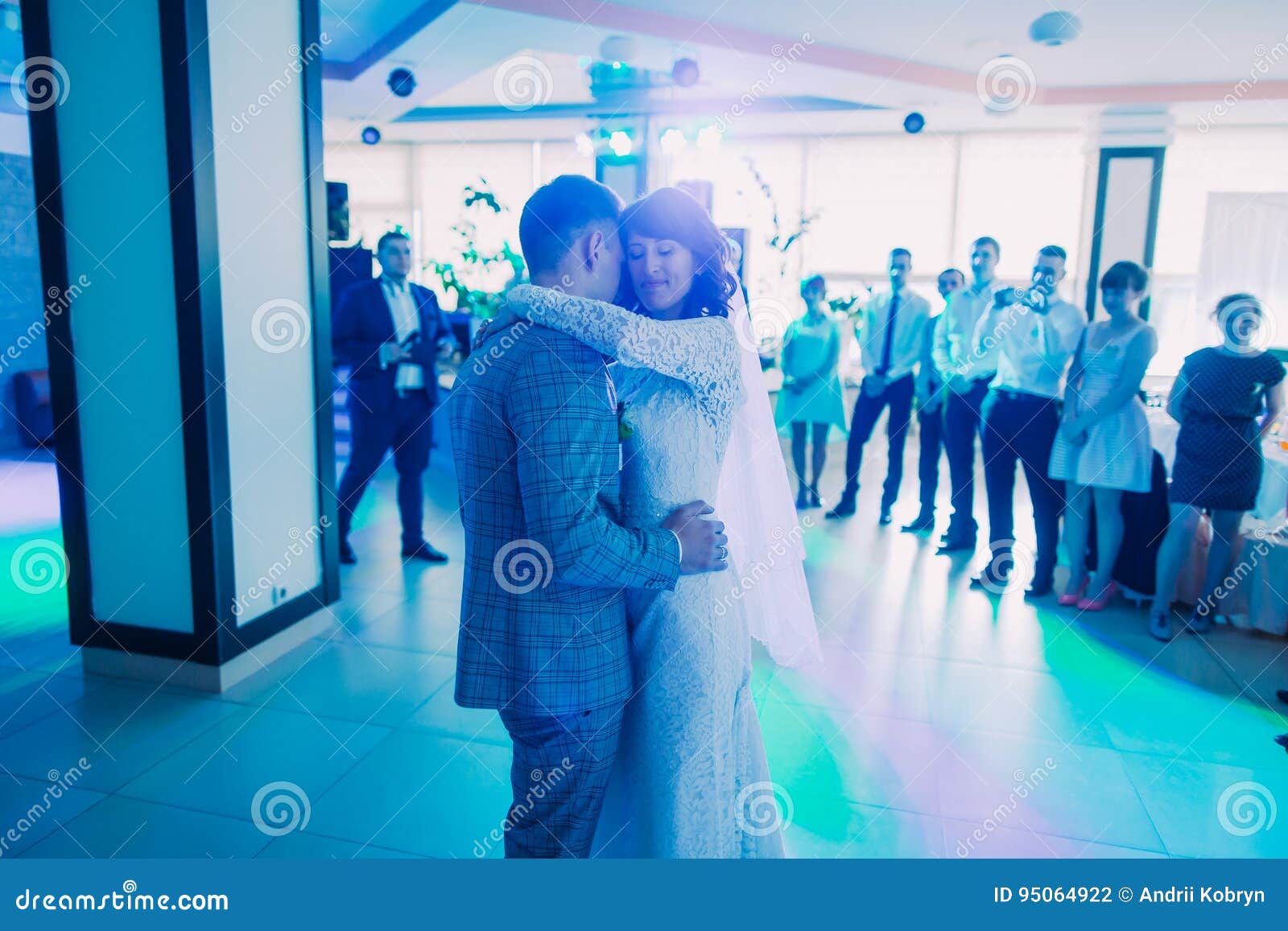 The First Dance of the Newlyweds in the Blue Lighting. Stock Photo