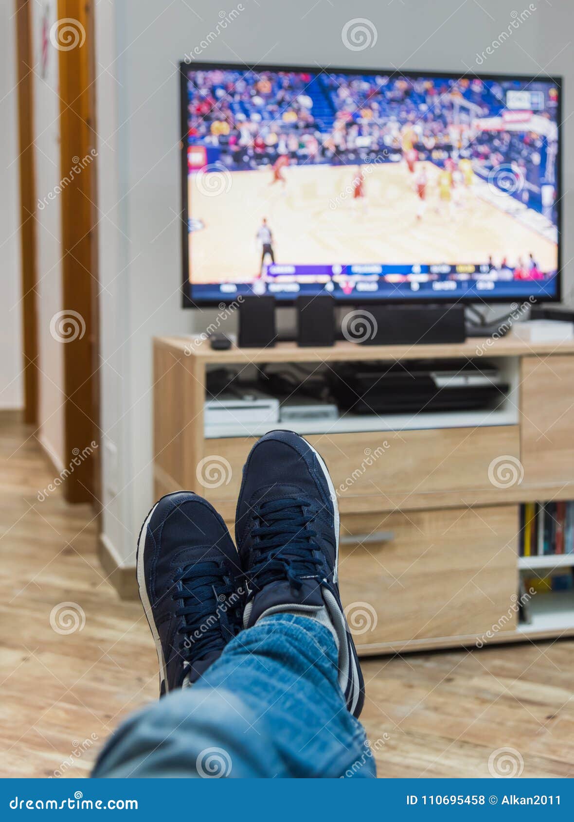 Man Watching a Basketball Game on Tv Stock Photo